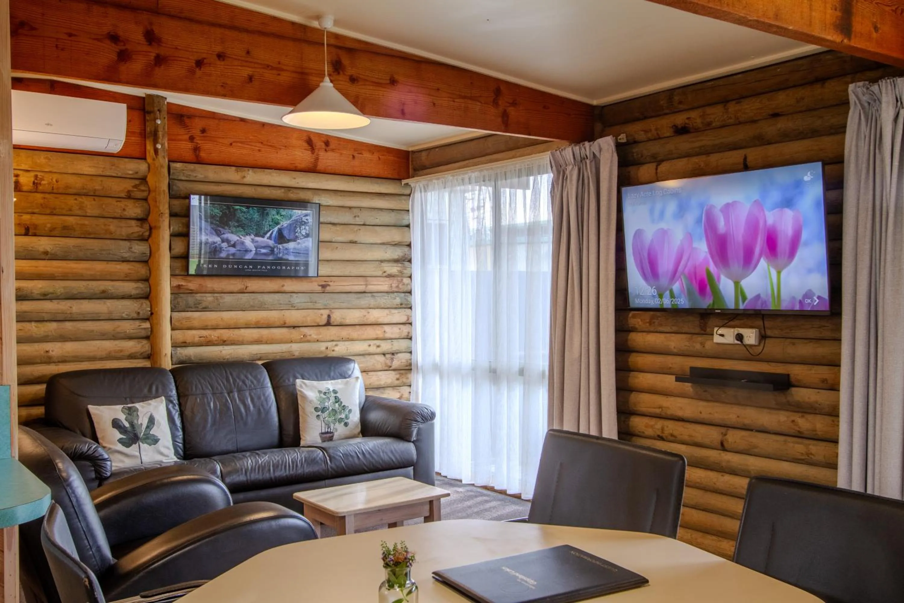Communal lounge/ TV room in Lazy Acre Log Cabins