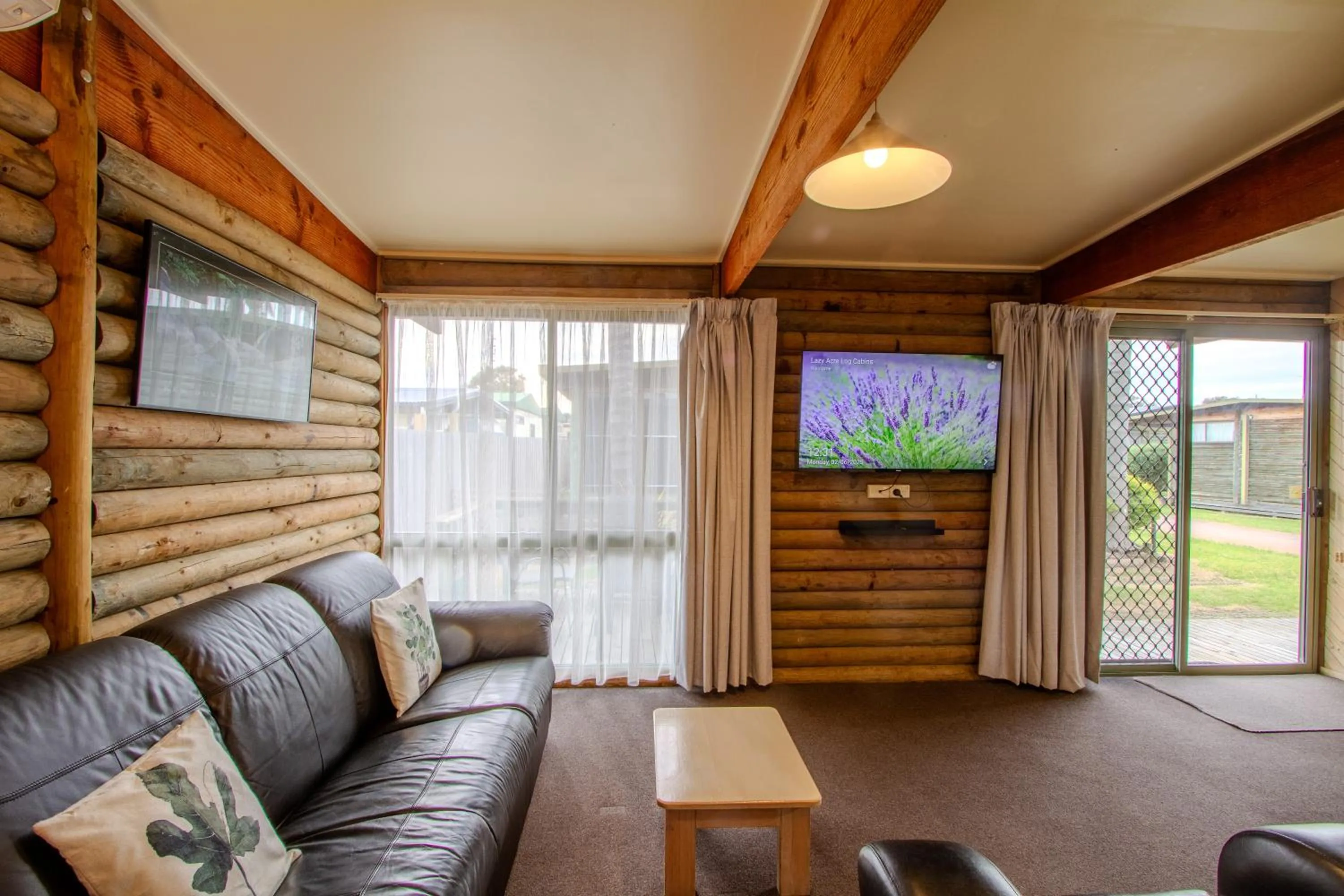 Seating area in Lazy Acre Log Cabins