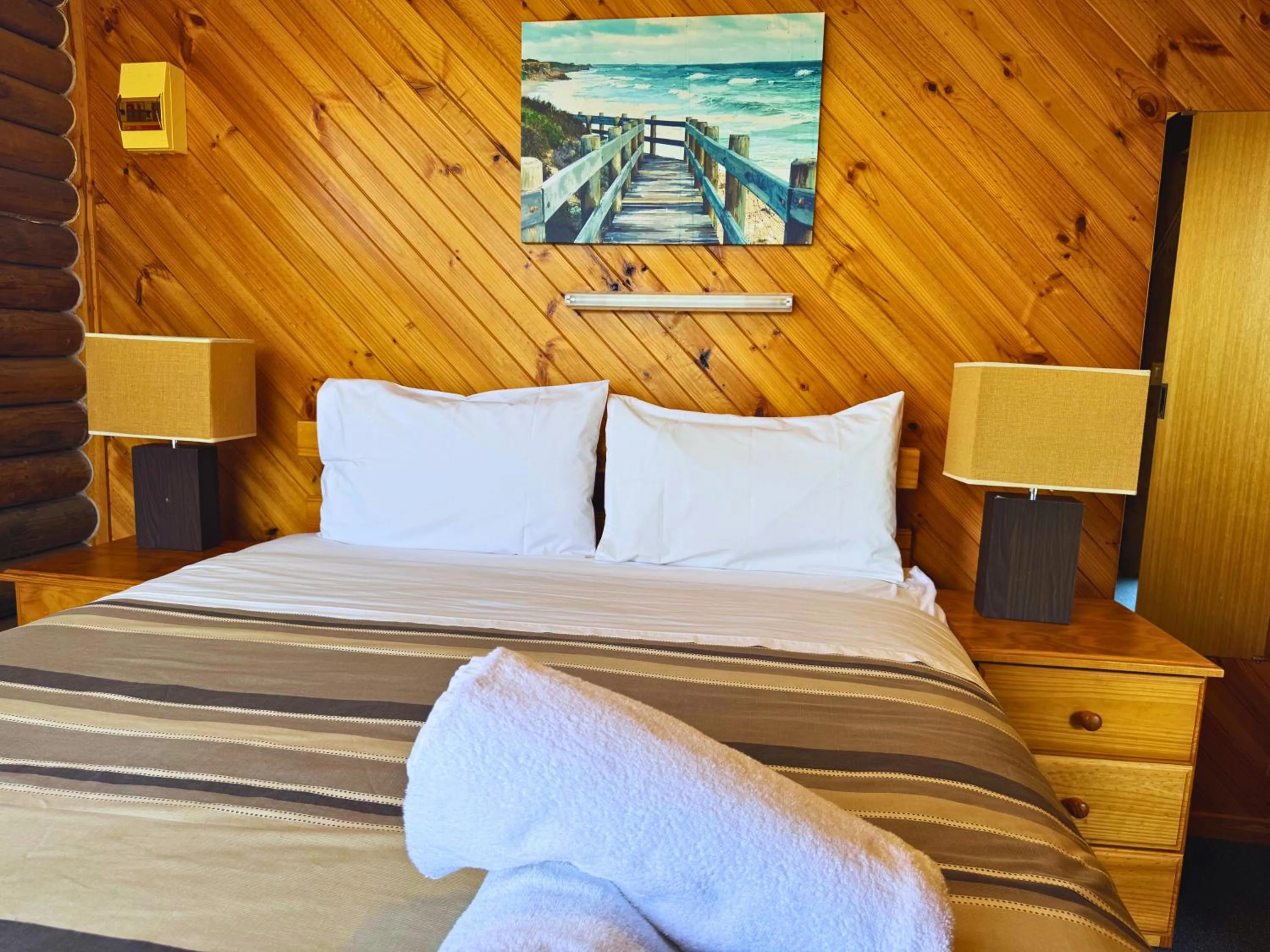 Bed in Lazy Acre Log Cabins