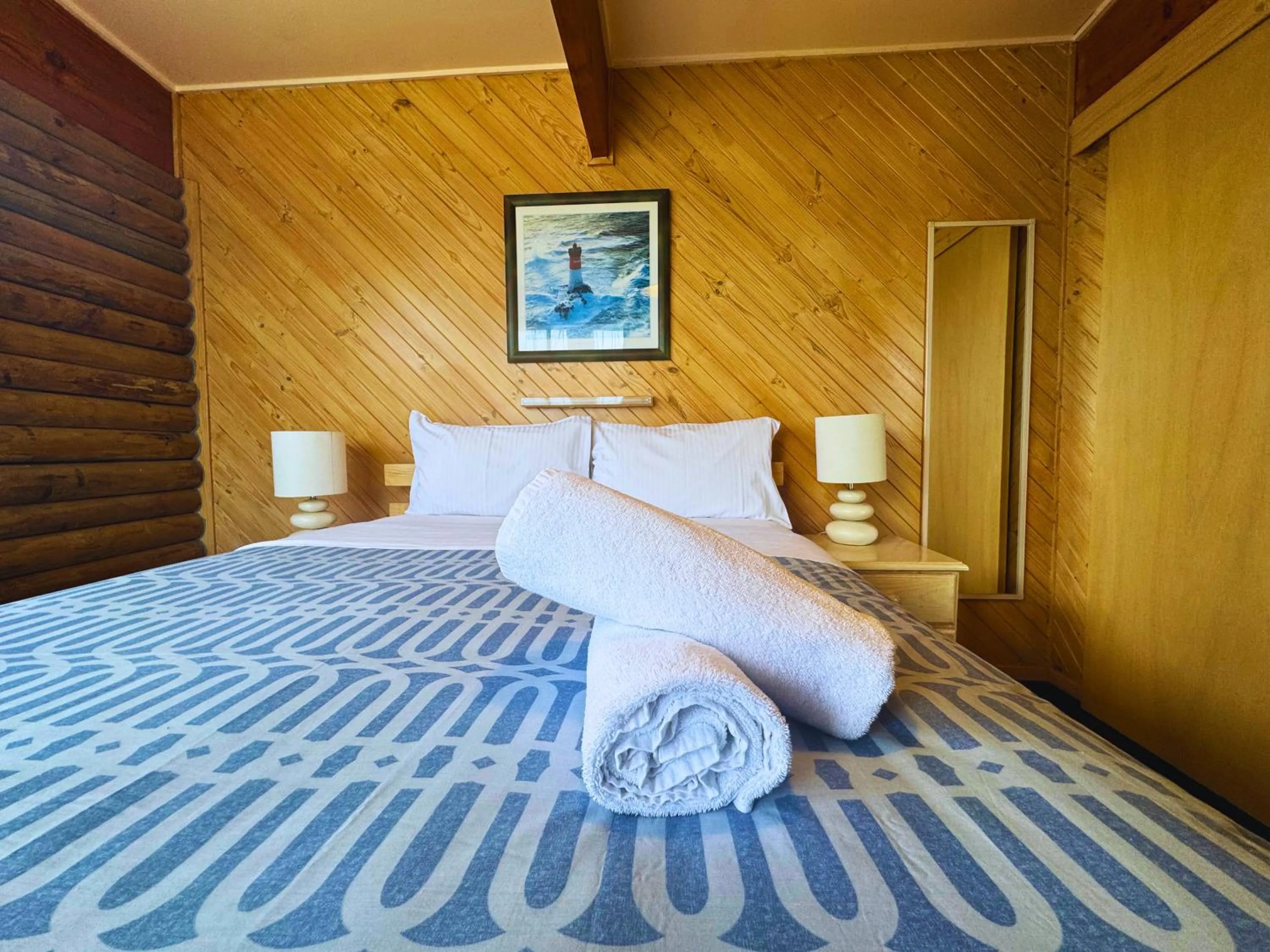 Bed in Lazy Acre Log Cabins