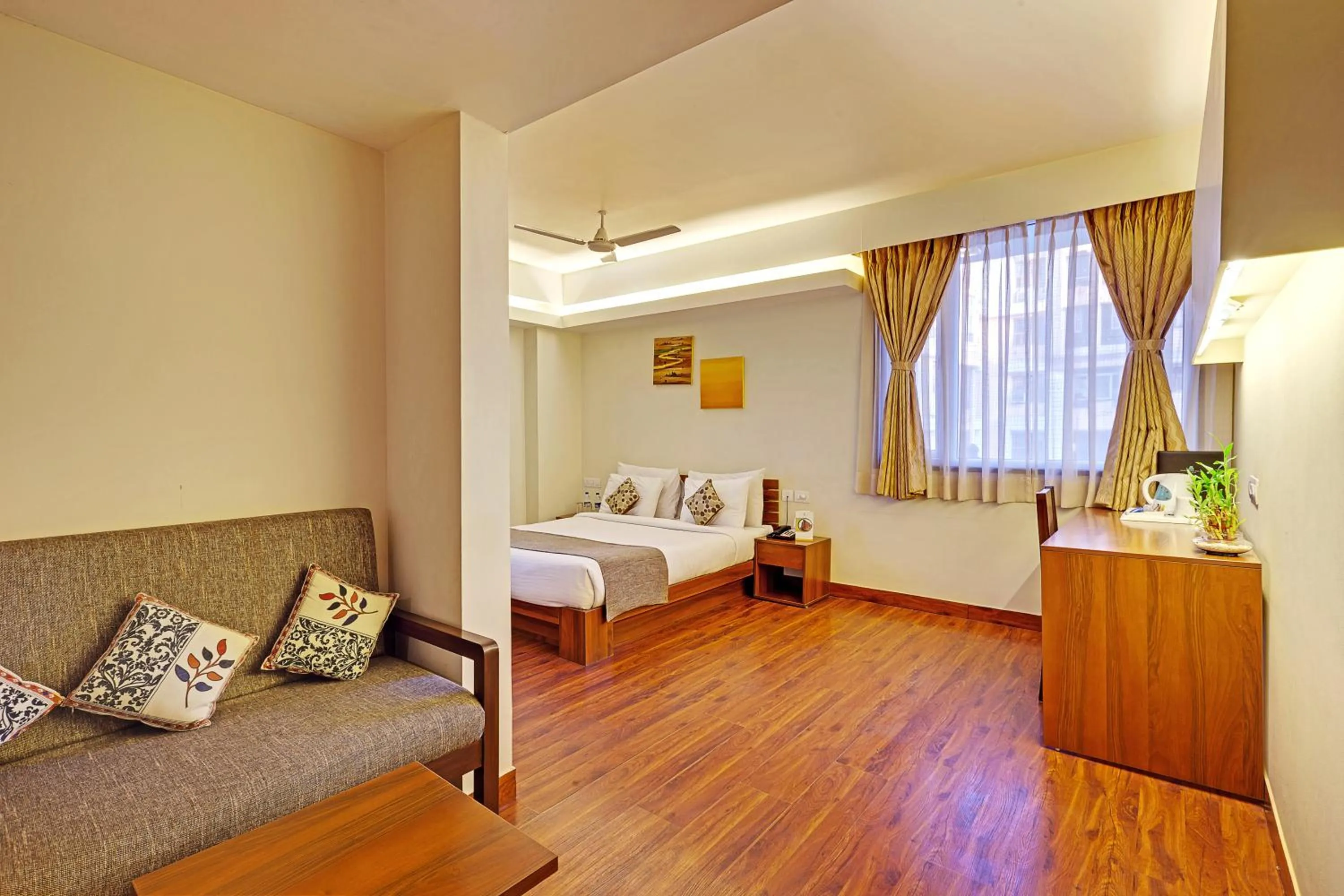 Seating area, Bed in Whispering Palms Hotel Jaipur