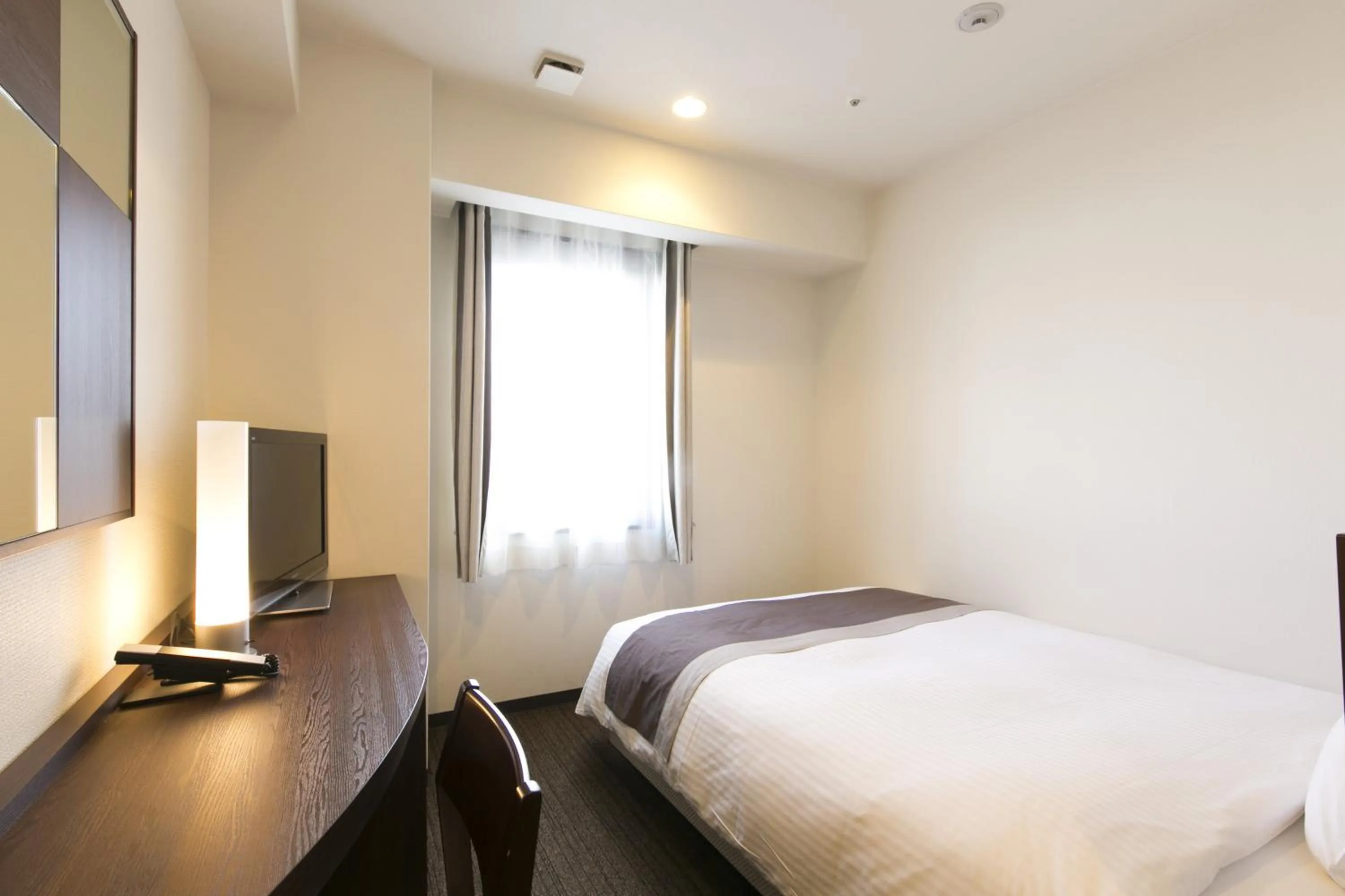 Bed in Urban Hotel Minami Kusatsu