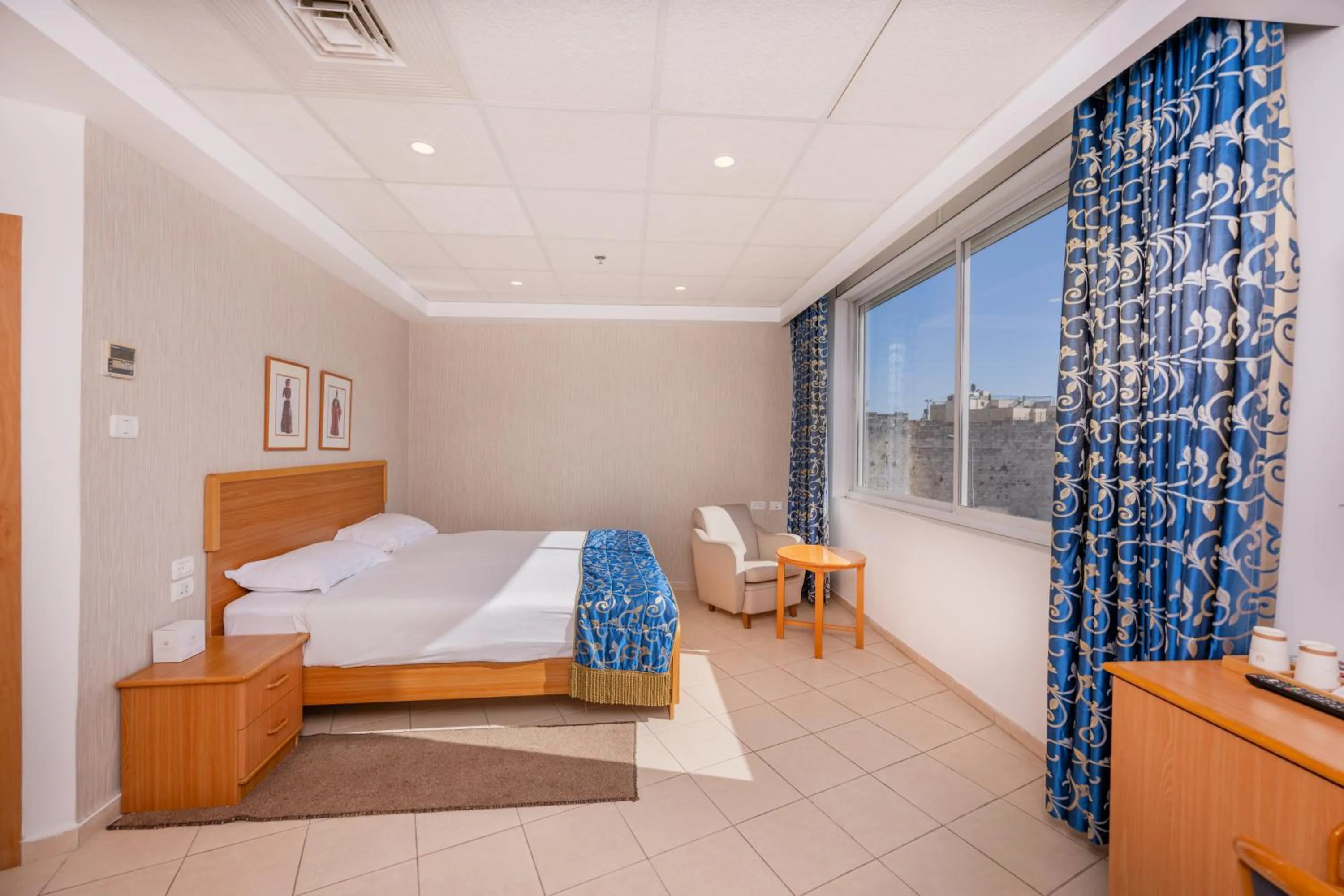 Bed in Golden Walls Hotel