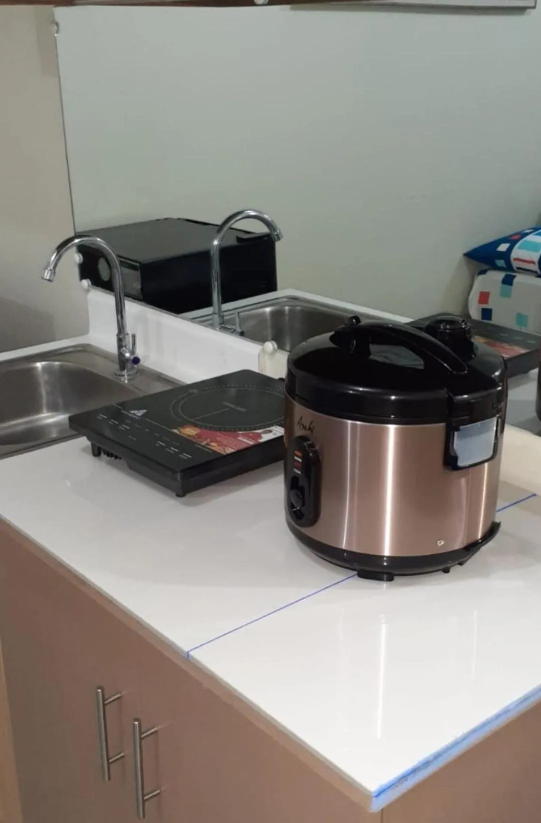 Kitchen or kitchenette in Staycation condo with pool near SM Tungko, Bulacan