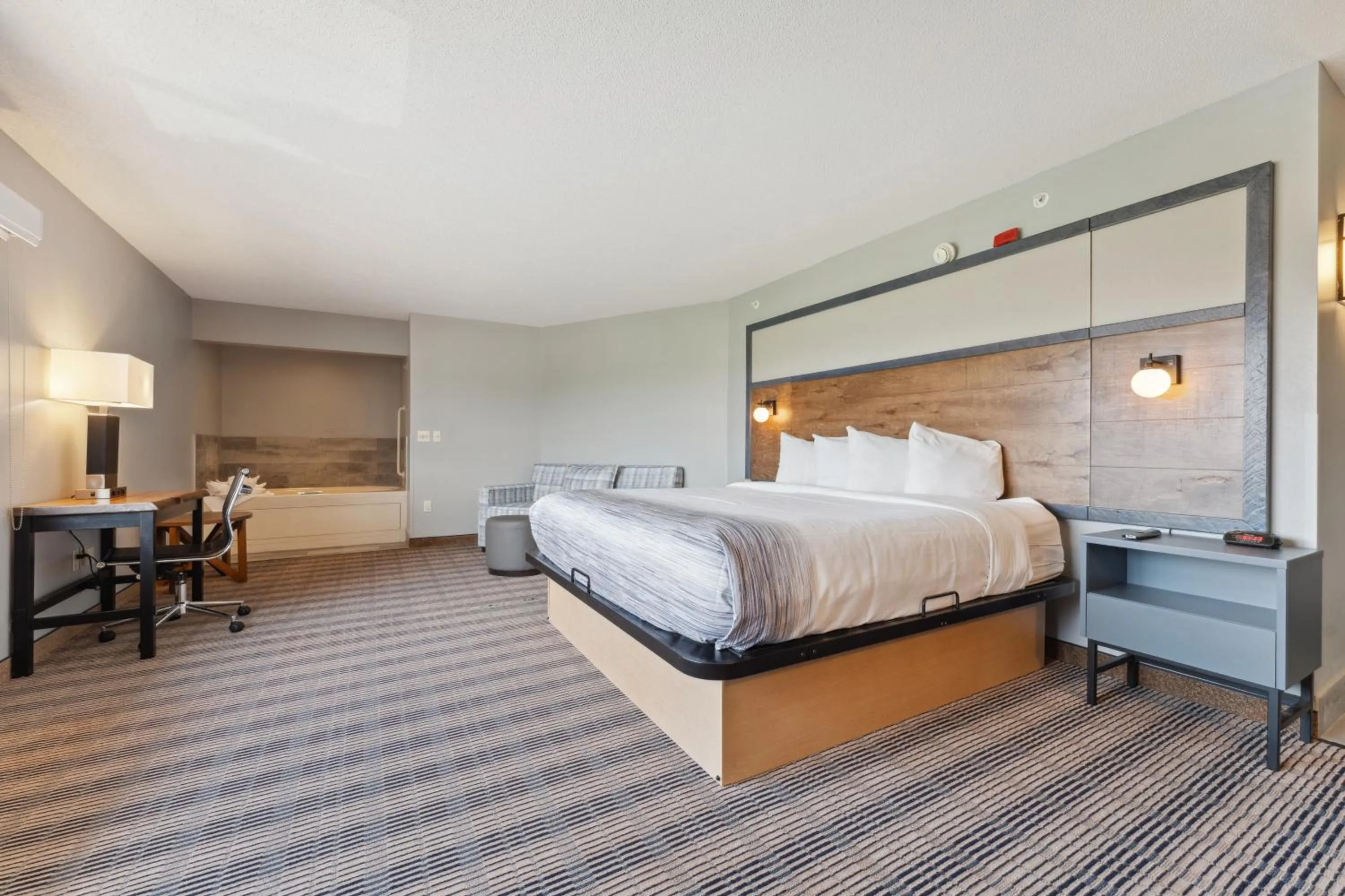 Bed in AmericInn by Wyndham Wisconsin Dells