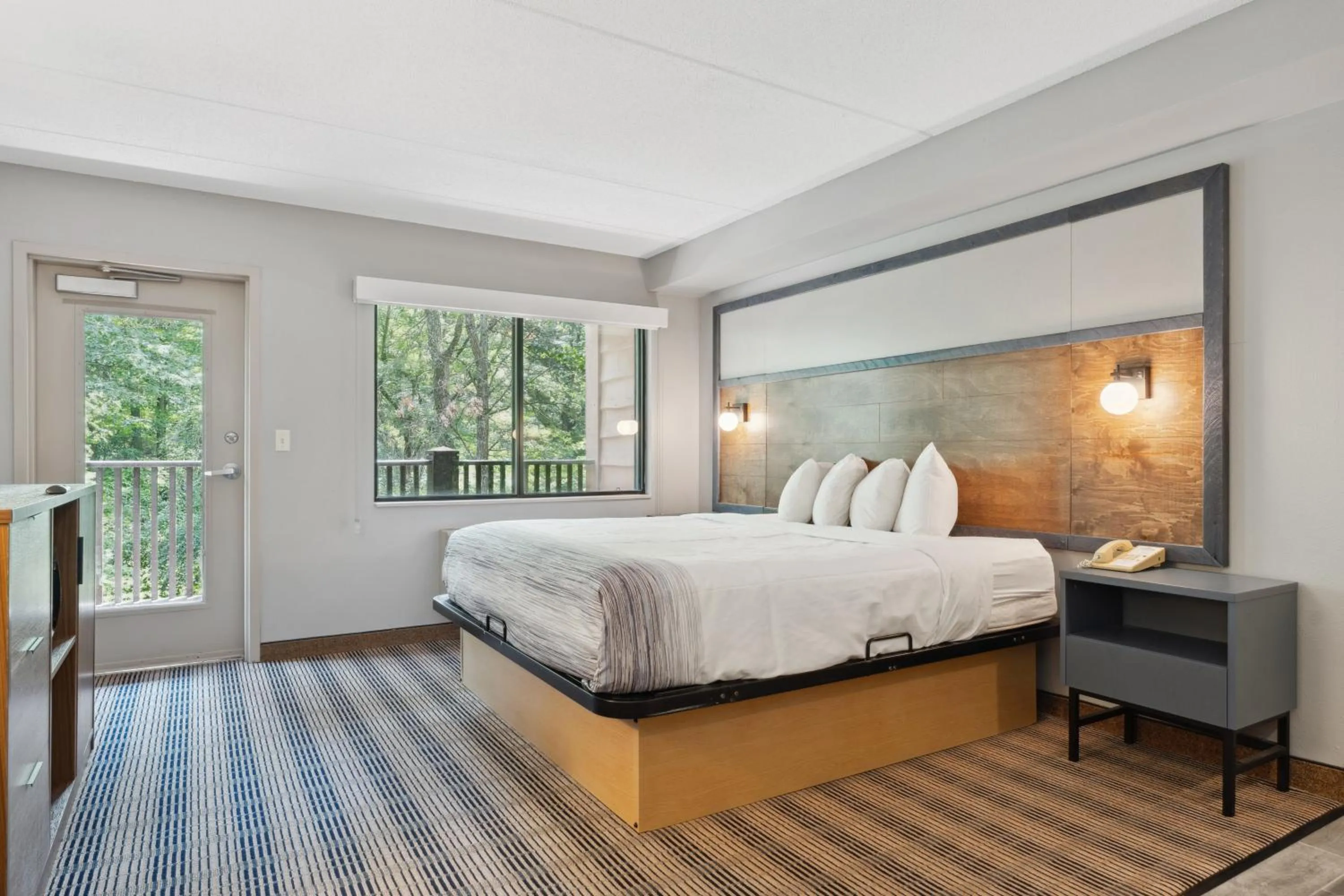 Bed in AmericInn by Wyndham Wisconsin Dells