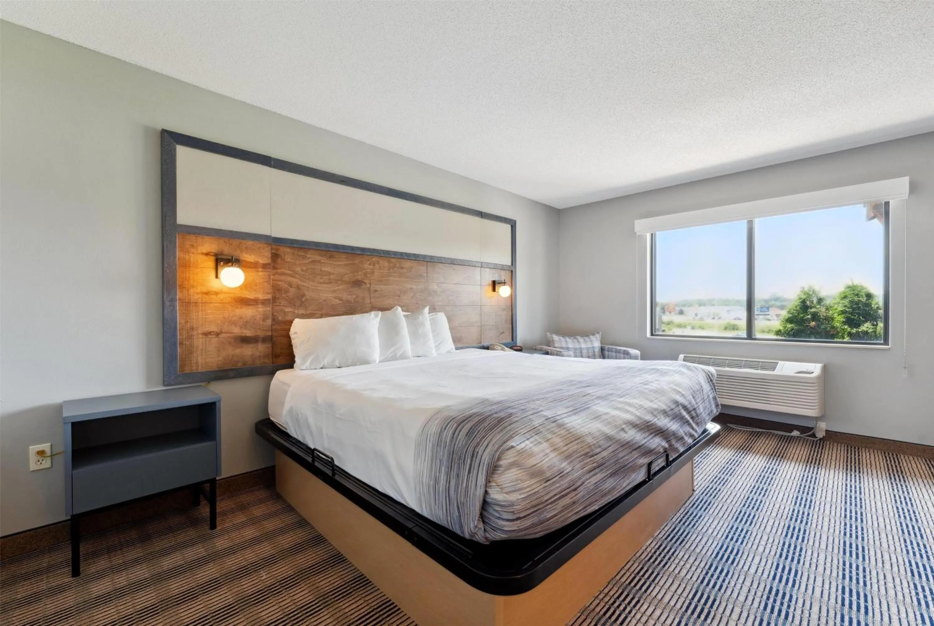 Bed in AmericInn by Wyndham Wisconsin Dells