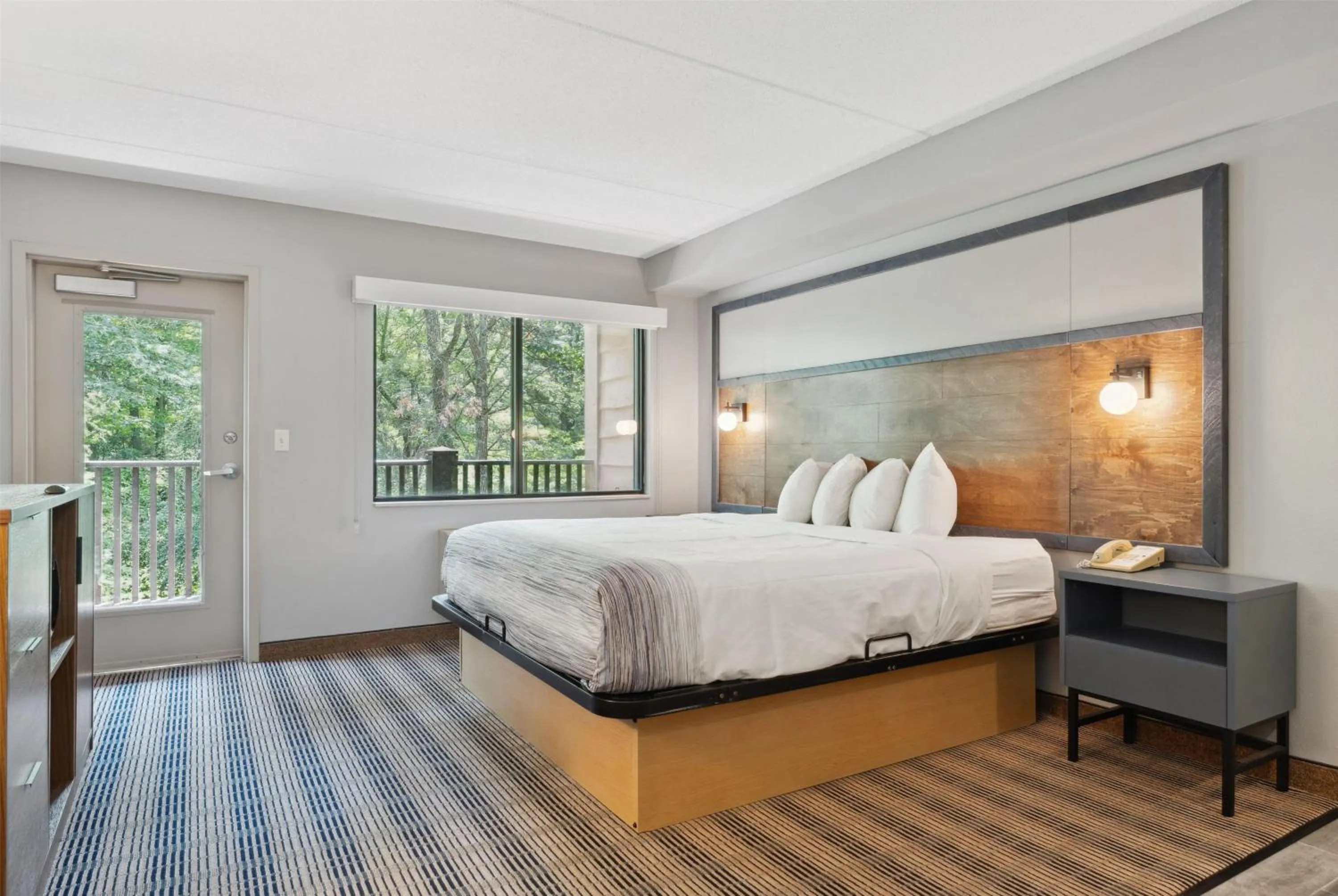 Bed in AmericInn by Wyndham Wisconsin Dells