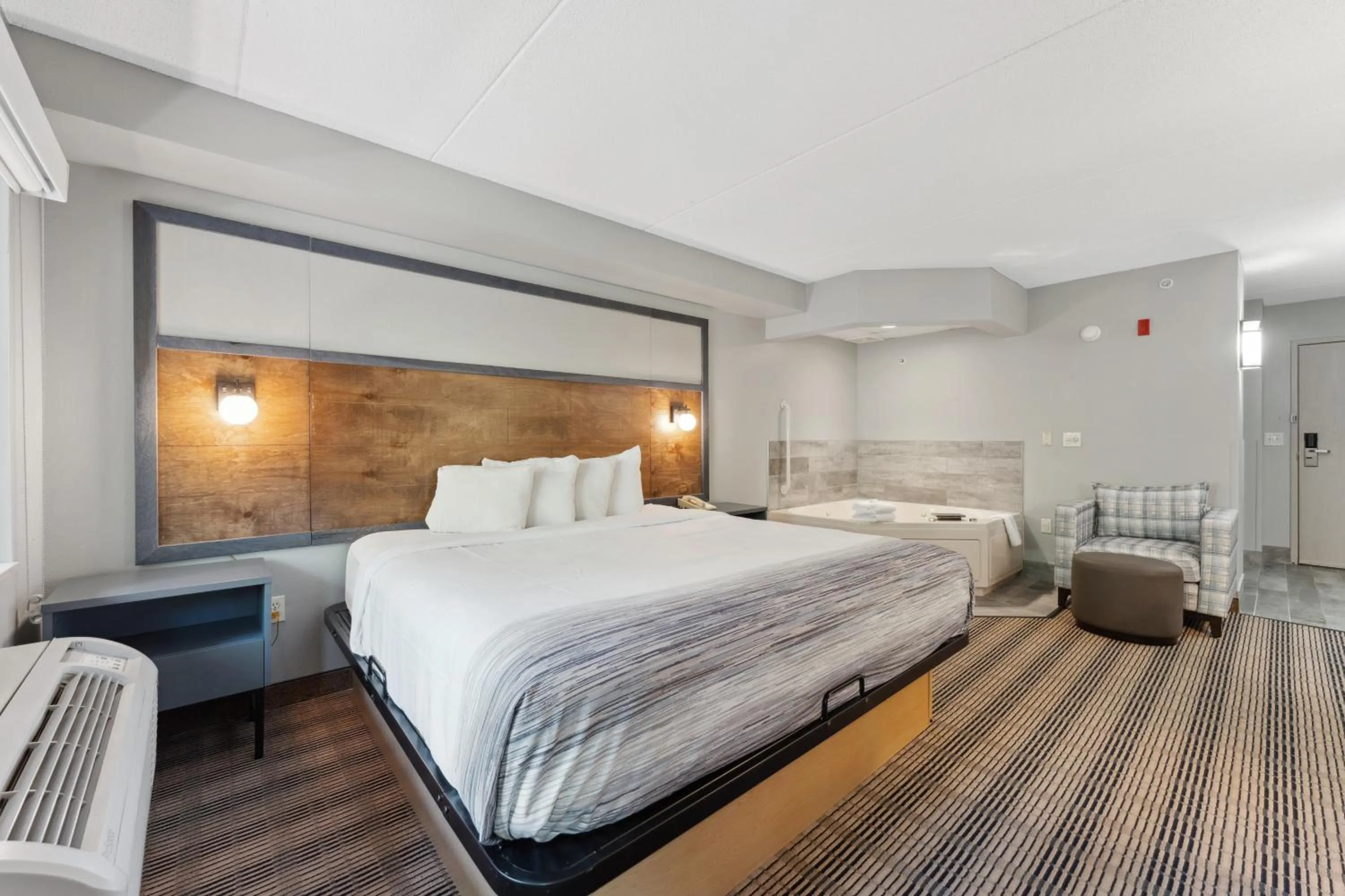 Bed in AmericInn by Wyndham Wisconsin Dells