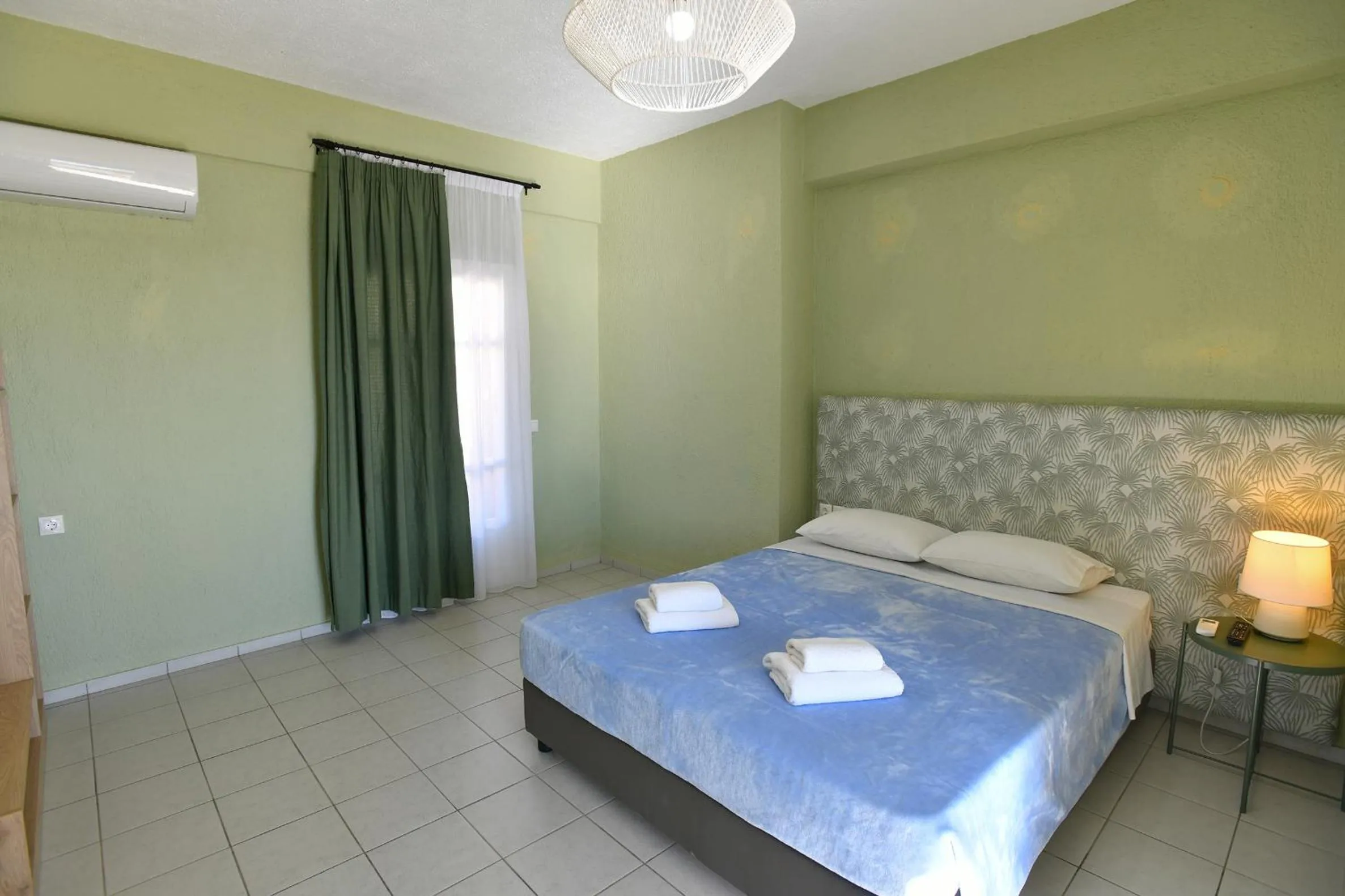 Bed in Triton Authentic Cretan Hotel