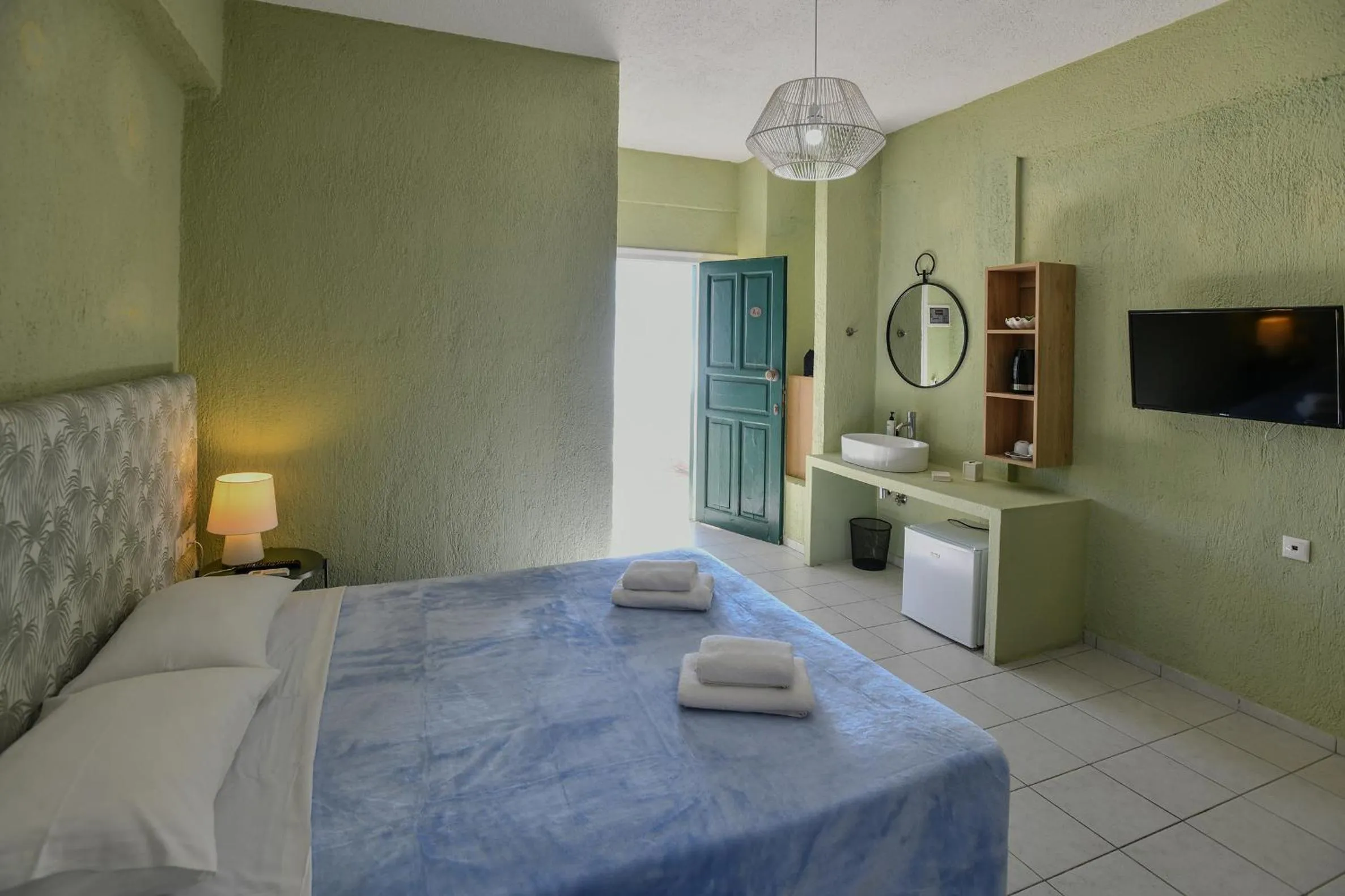 Bed in Triton Authentic Cretan Hotel