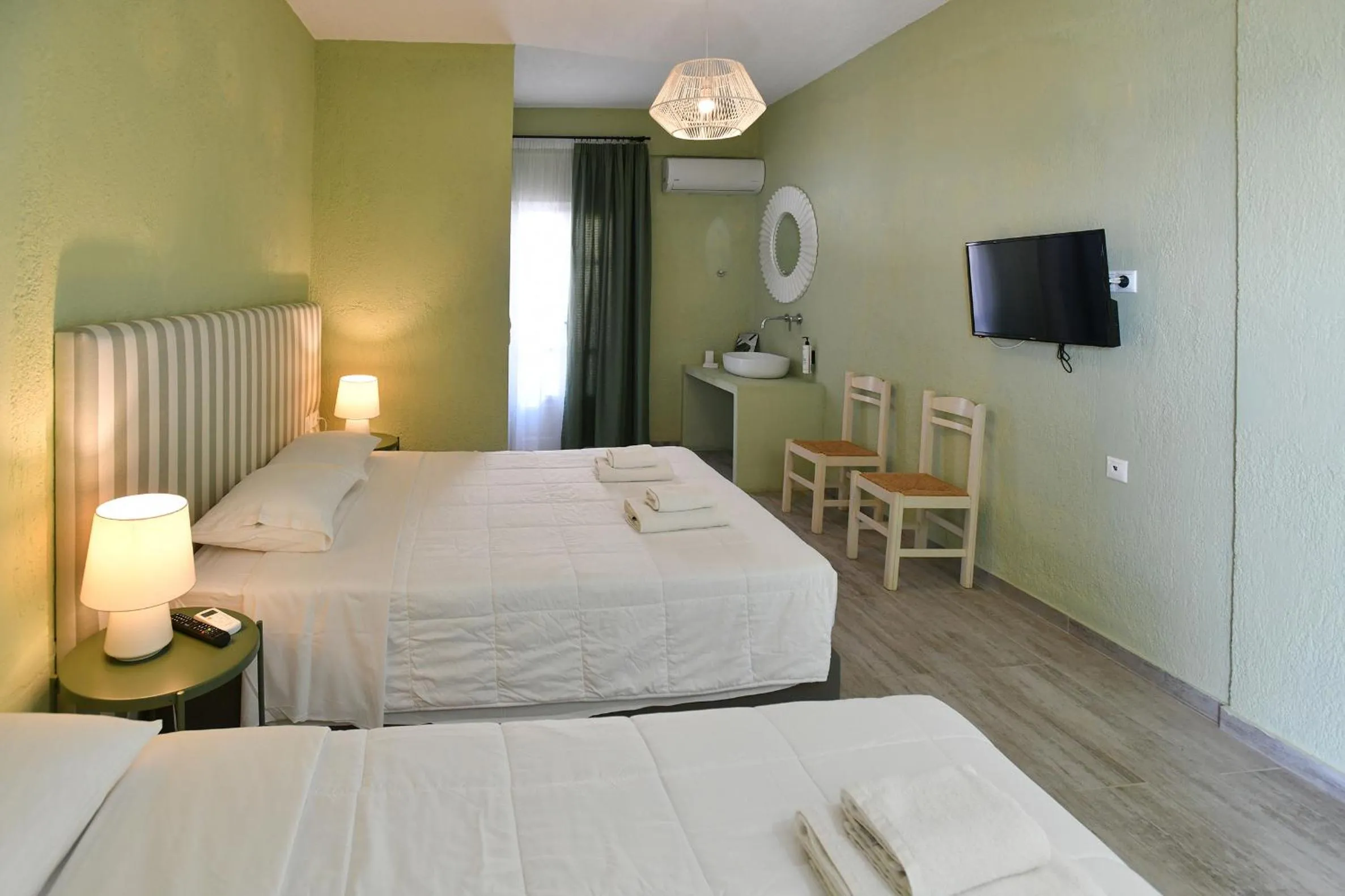 Bed in Triton Authentic Cretan Hotel