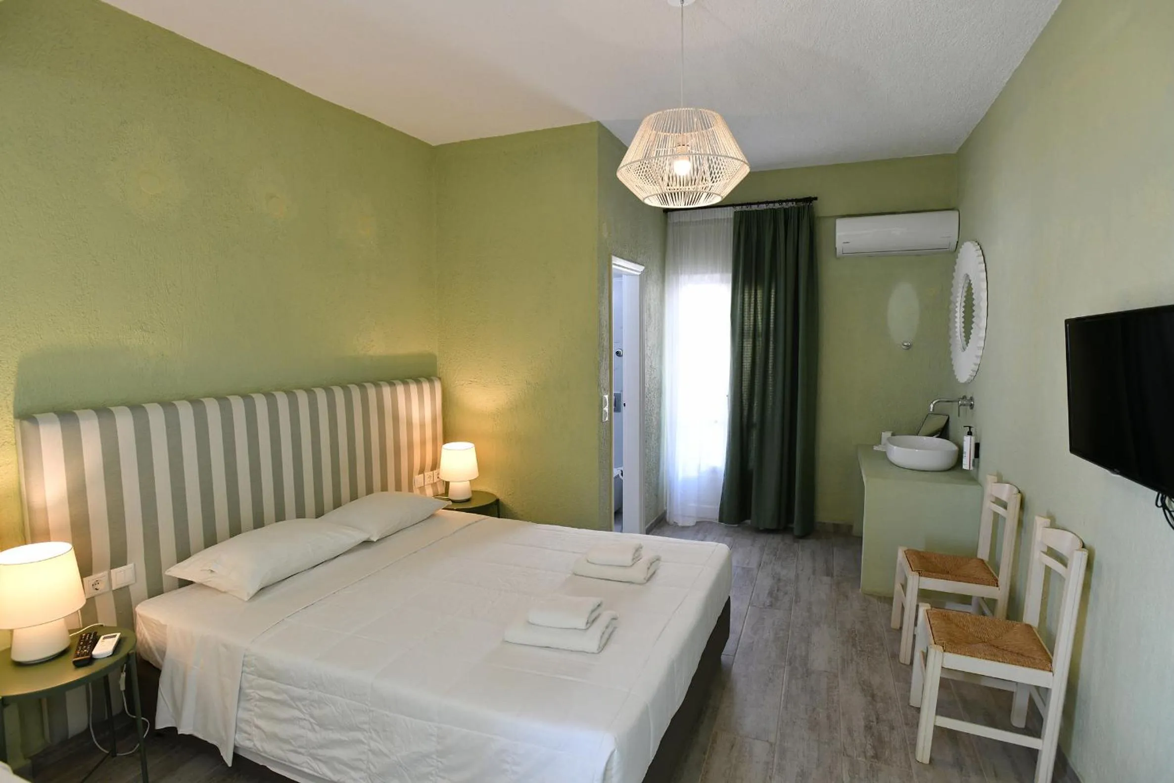 Bed in Triton Authentic Cretan Hotel