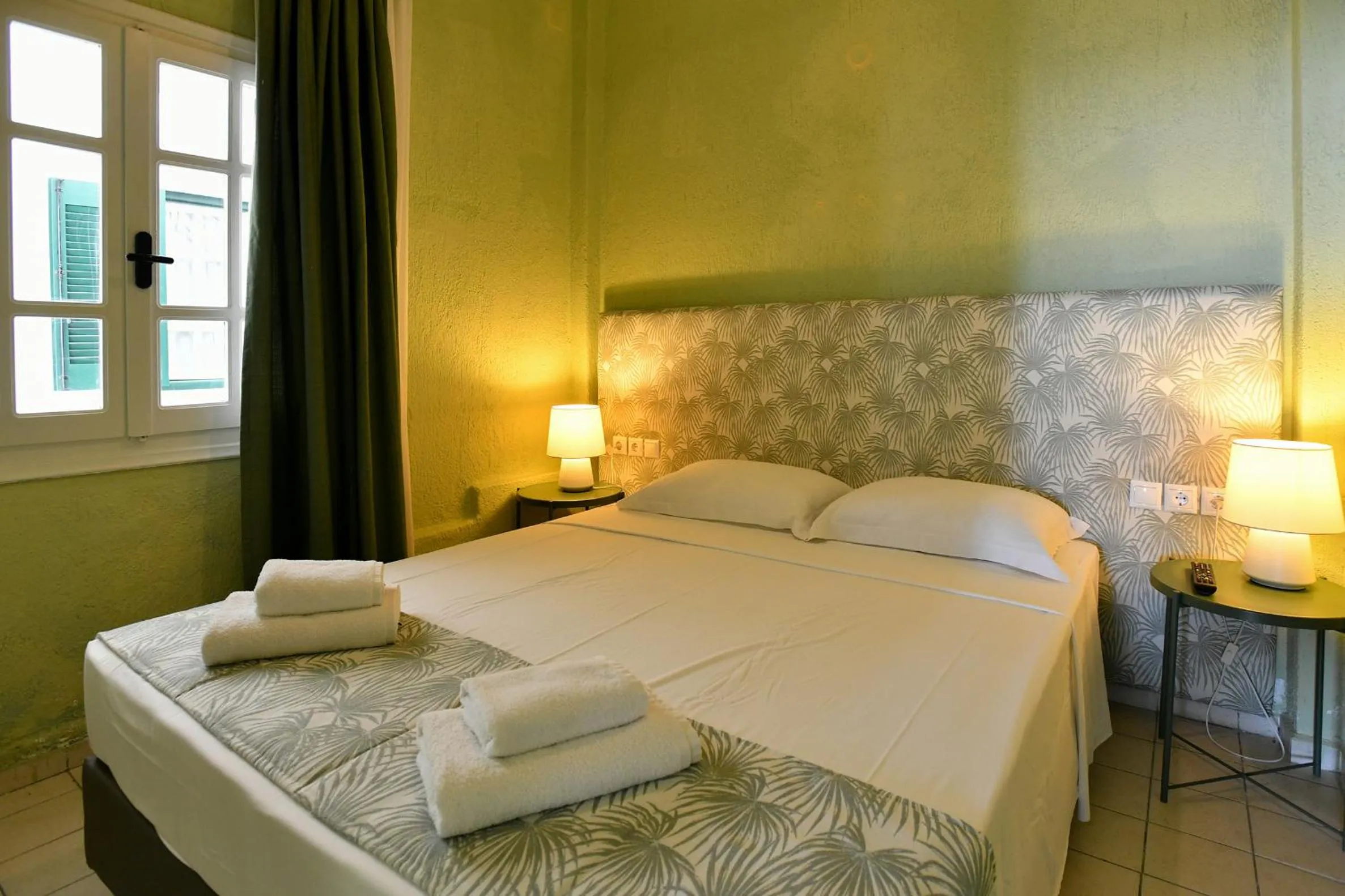 Bed in Triton Authentic Cretan Hotel