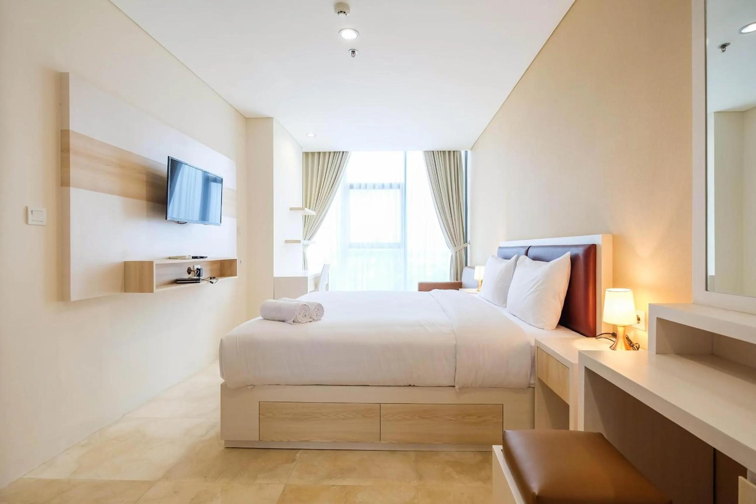 Bed in 2BR Cozy and Modern L'Avenue Apartment By Travelio