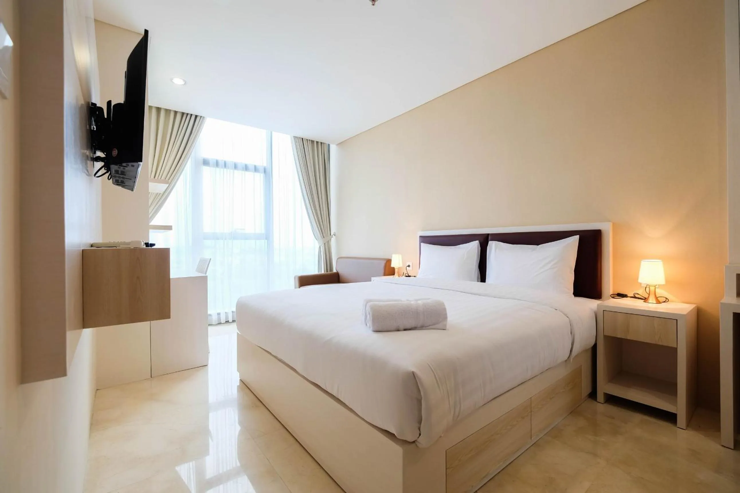 Bed in 2BR Cozy and Modern L'Avenue Apartment By Travelio