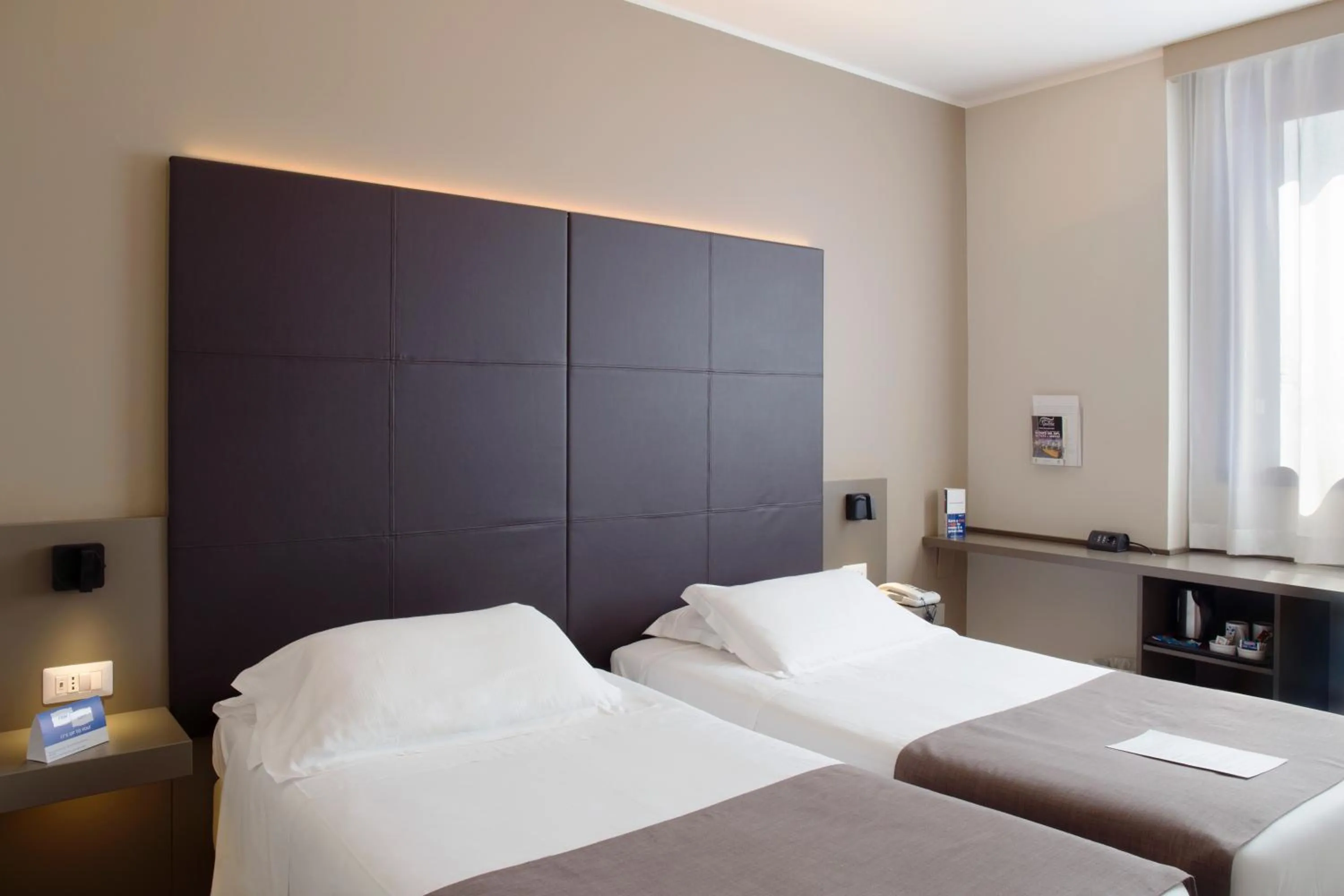 Bed in City Hotel & Suites