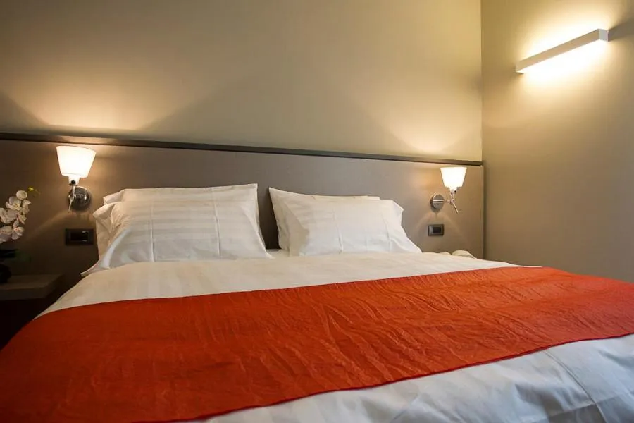 Bed in Zara Rooms & Suites