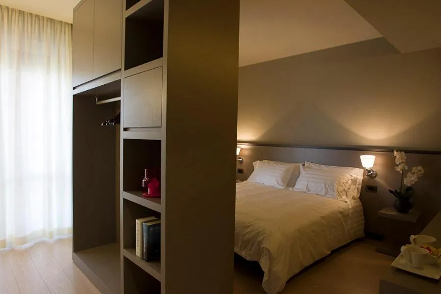 Bed in Zara Rooms & Suites
