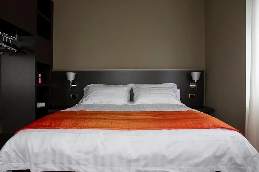 Bed in Zara Rooms & Suites