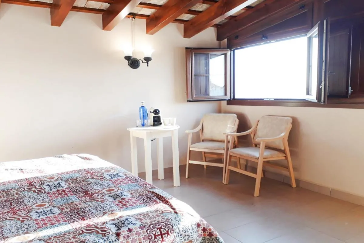 Seating area, Bed in Posada Alegria
