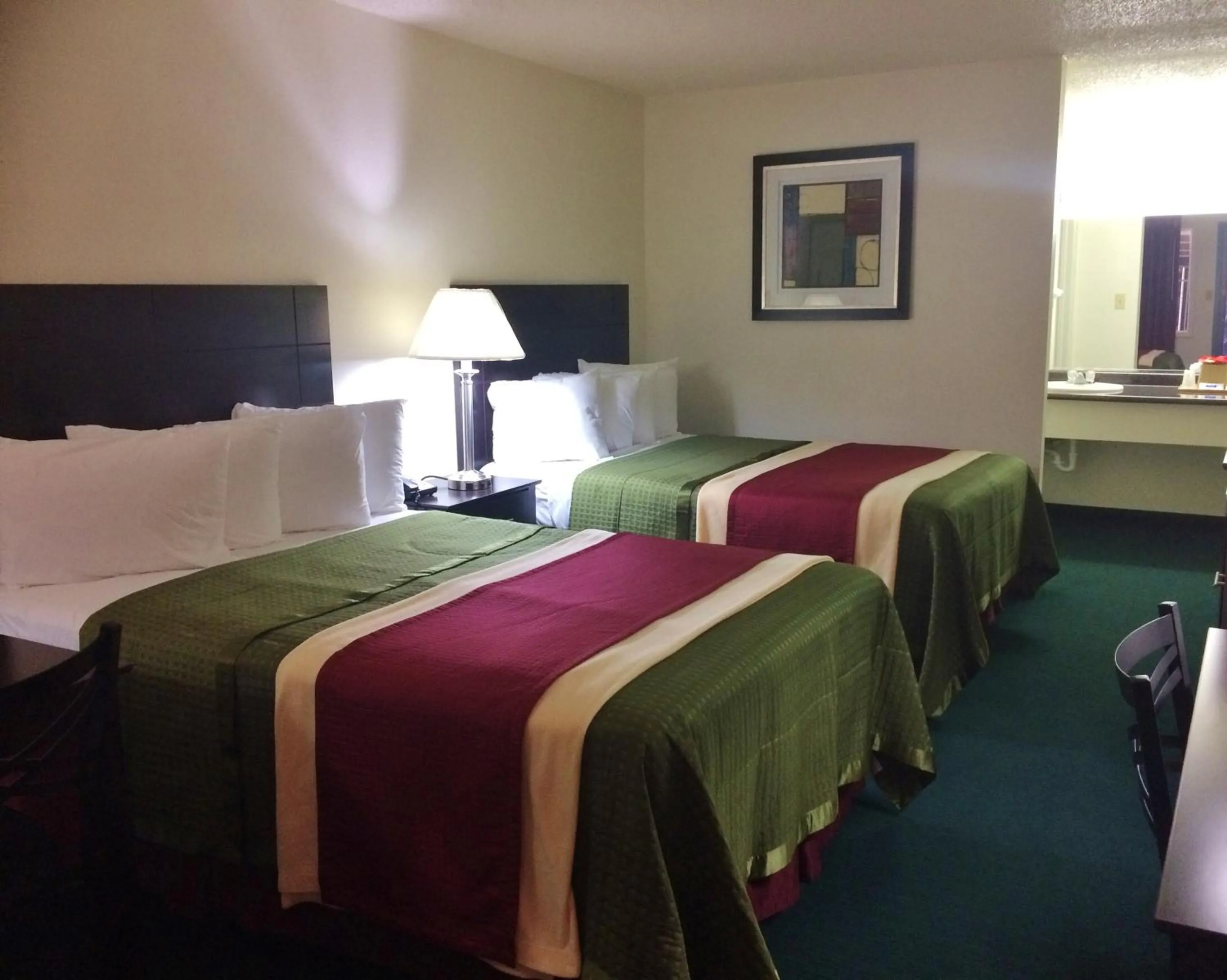 Bed in Travel Inn & Suites
