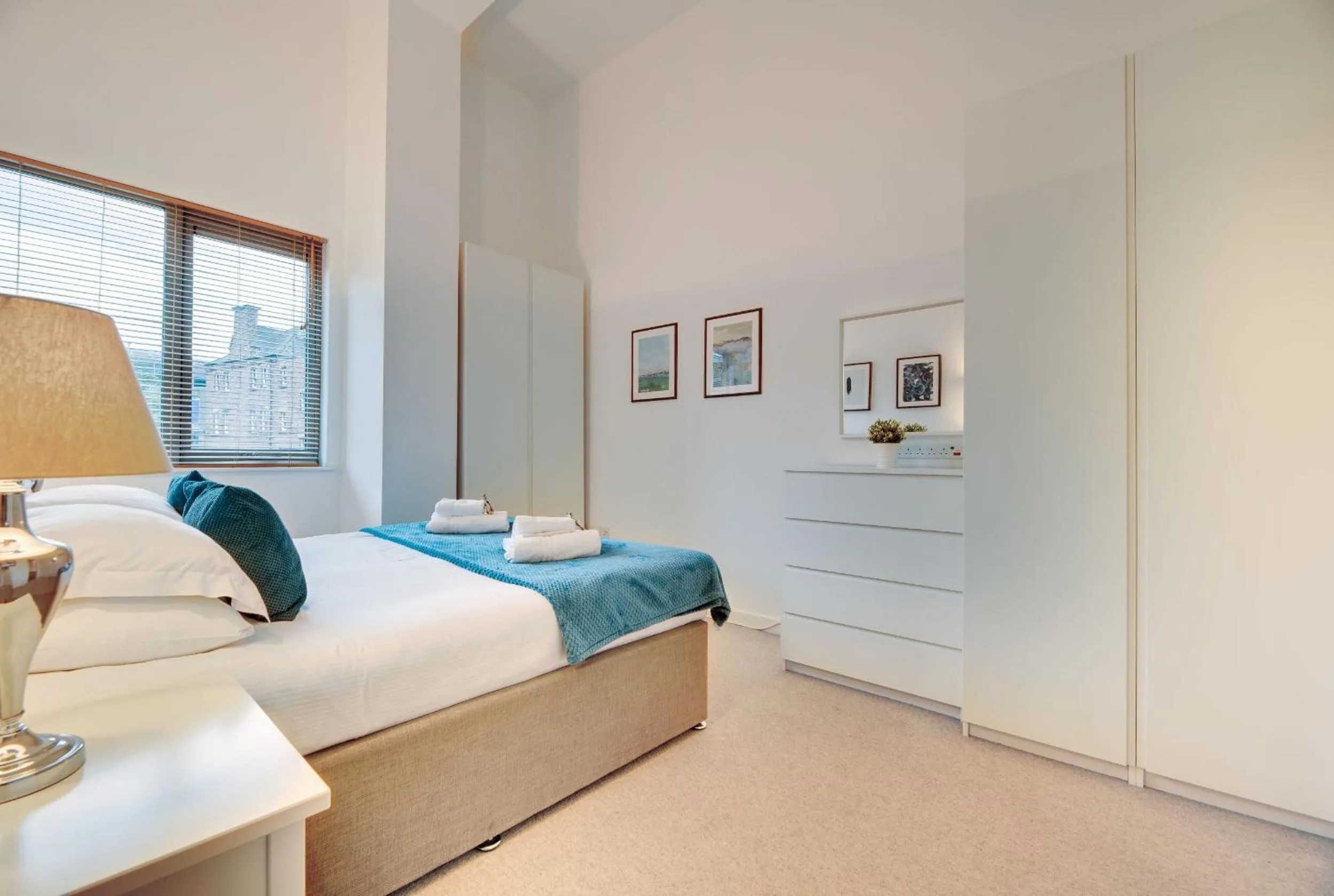 Bed in Crown Apartments 1C by Week2Week