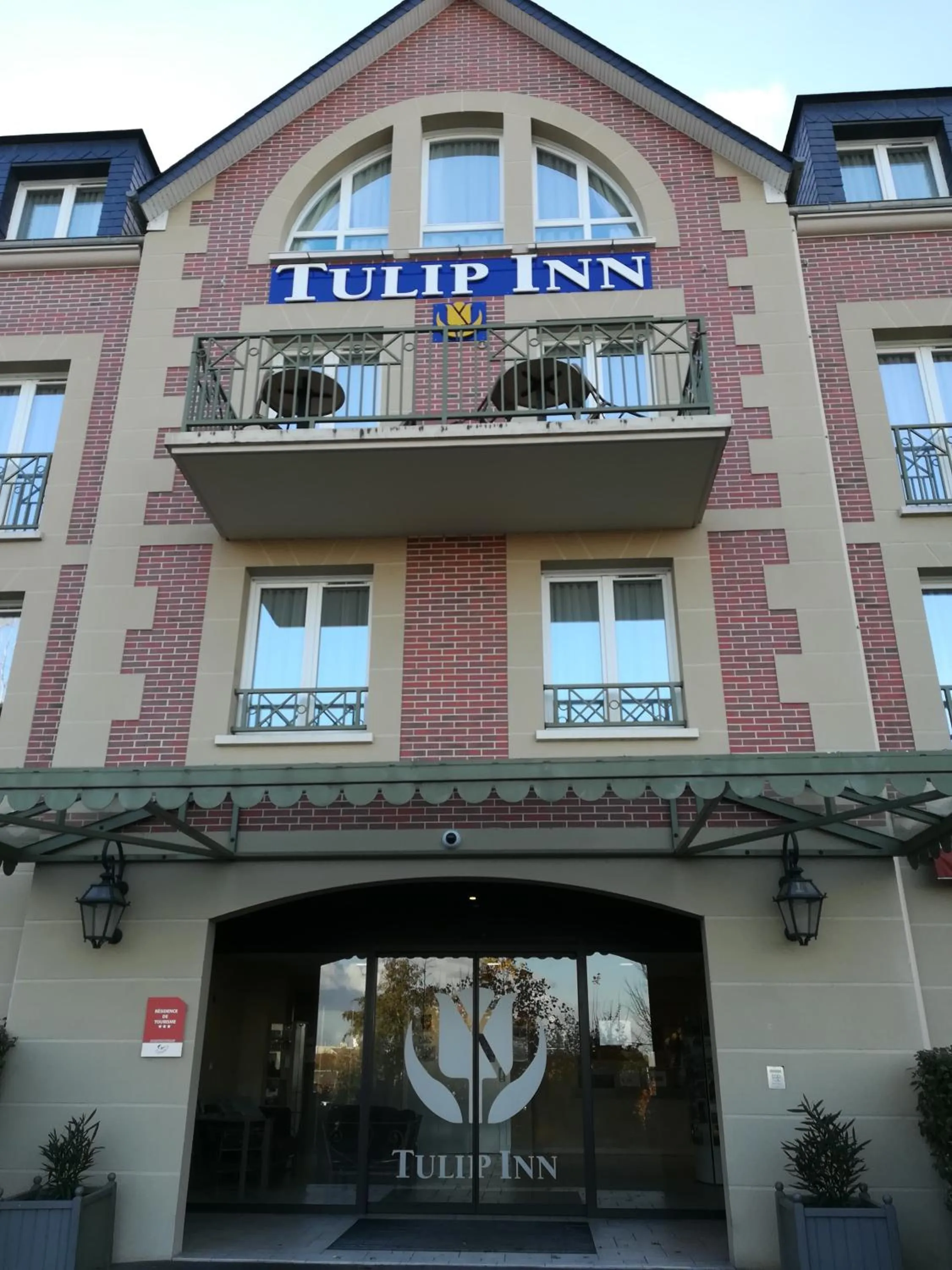 Property logo or sign in Tulip Inn Honfleur Residence &amp; Spa