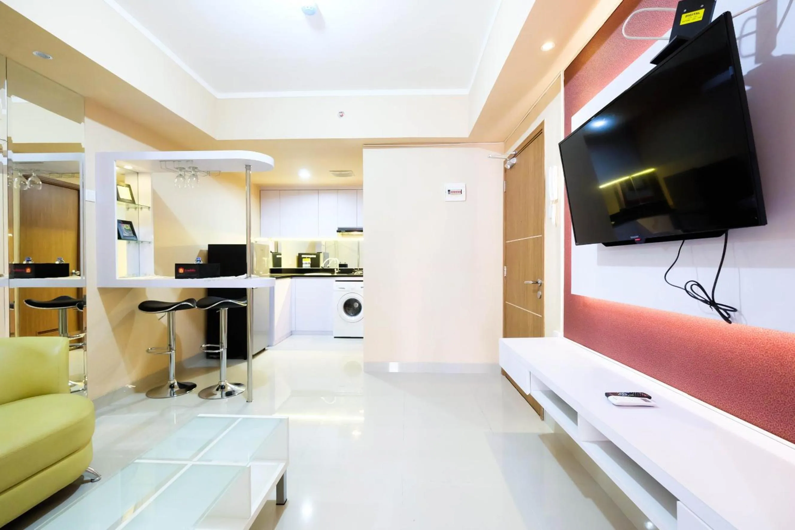 Living room in Bright and Stylish 1BR The Oasis Apartment Cikarang By Travelio