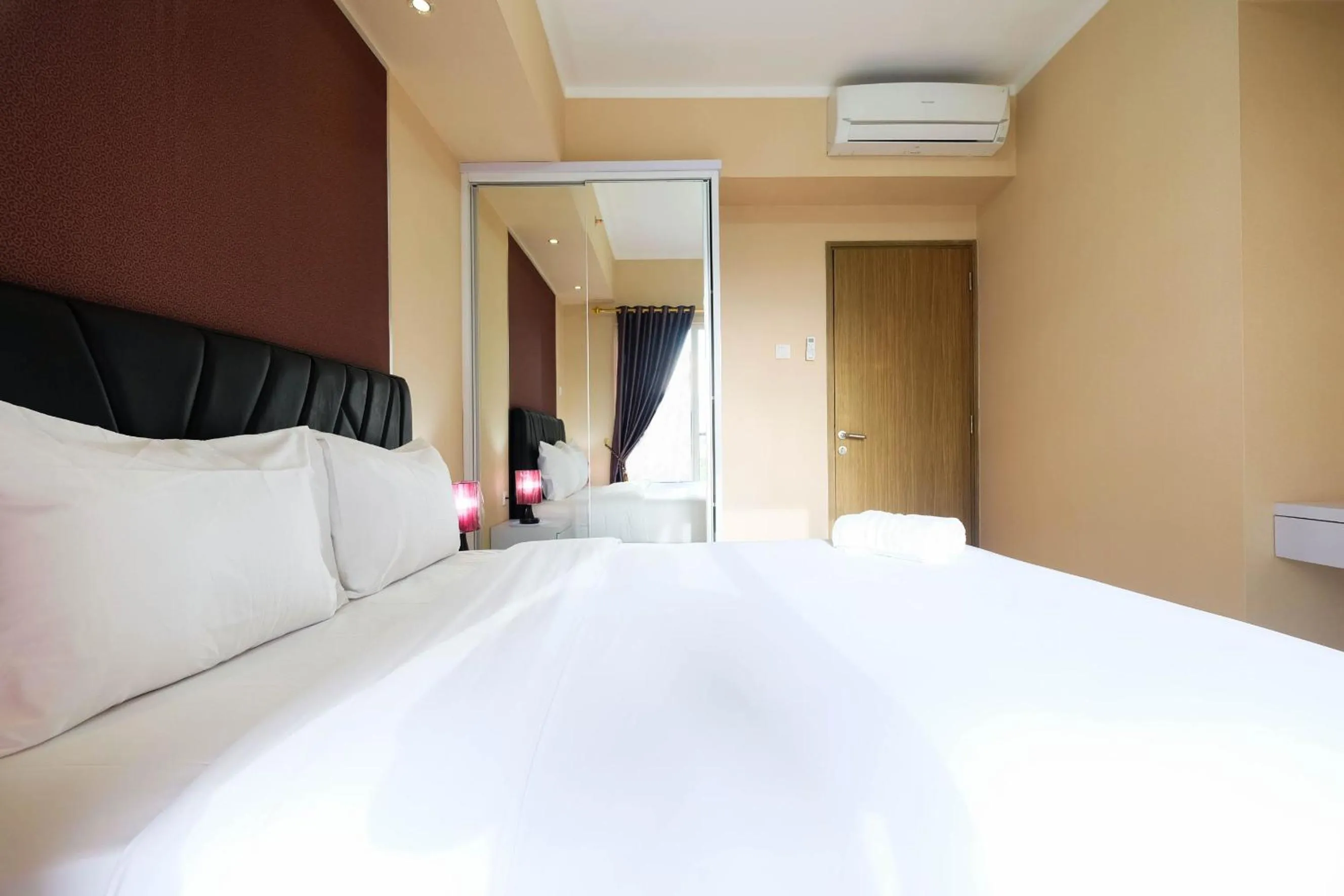 Bed in Bright and Stylish 1BR The Oasis Apartment Cikarang By Travelio