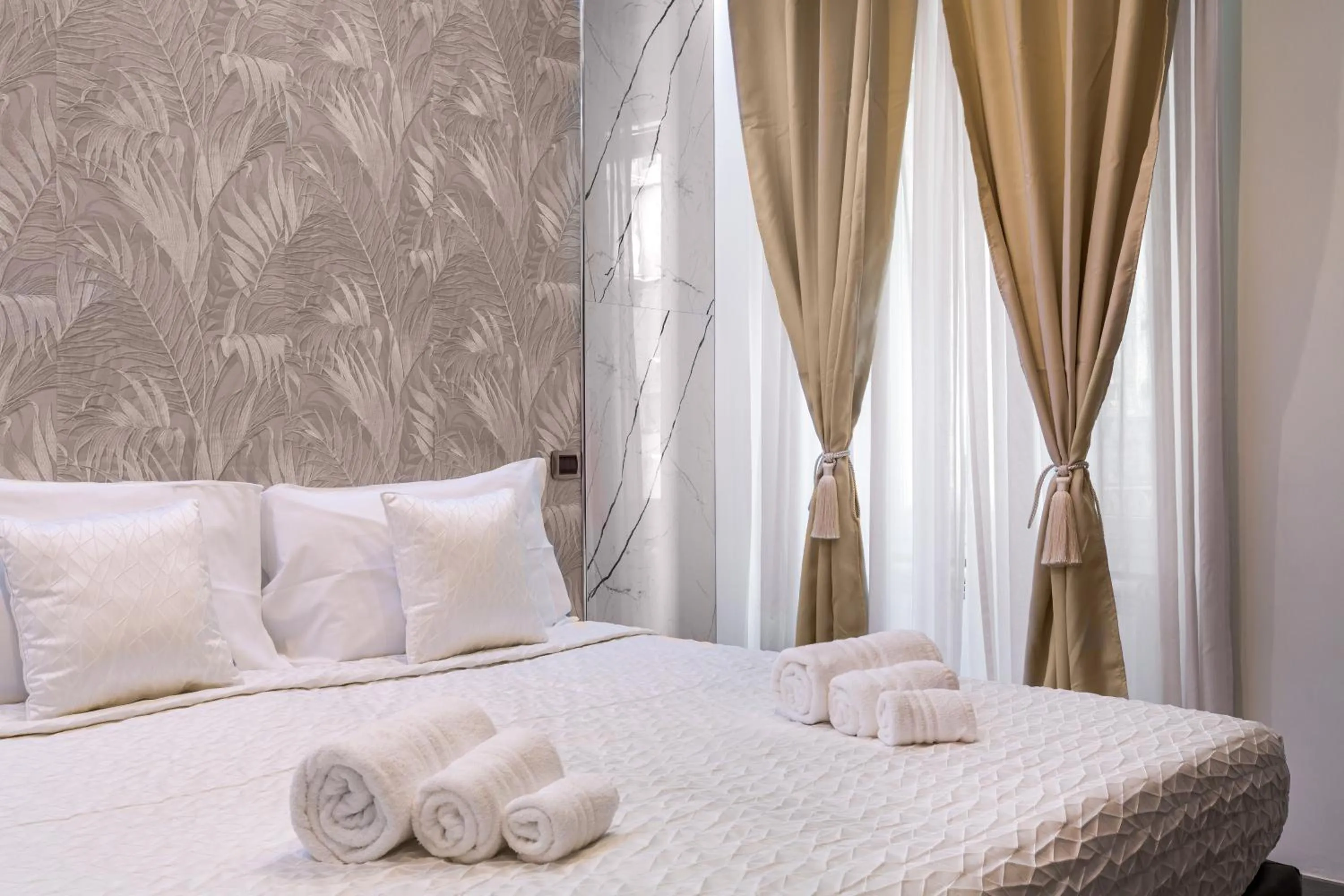 Bed in Daphne Suites