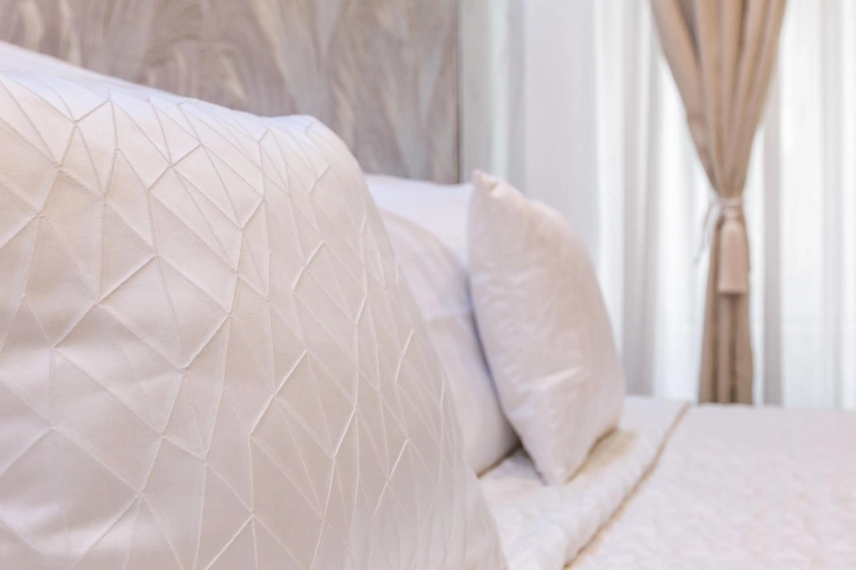 Bed in Daphne Suites