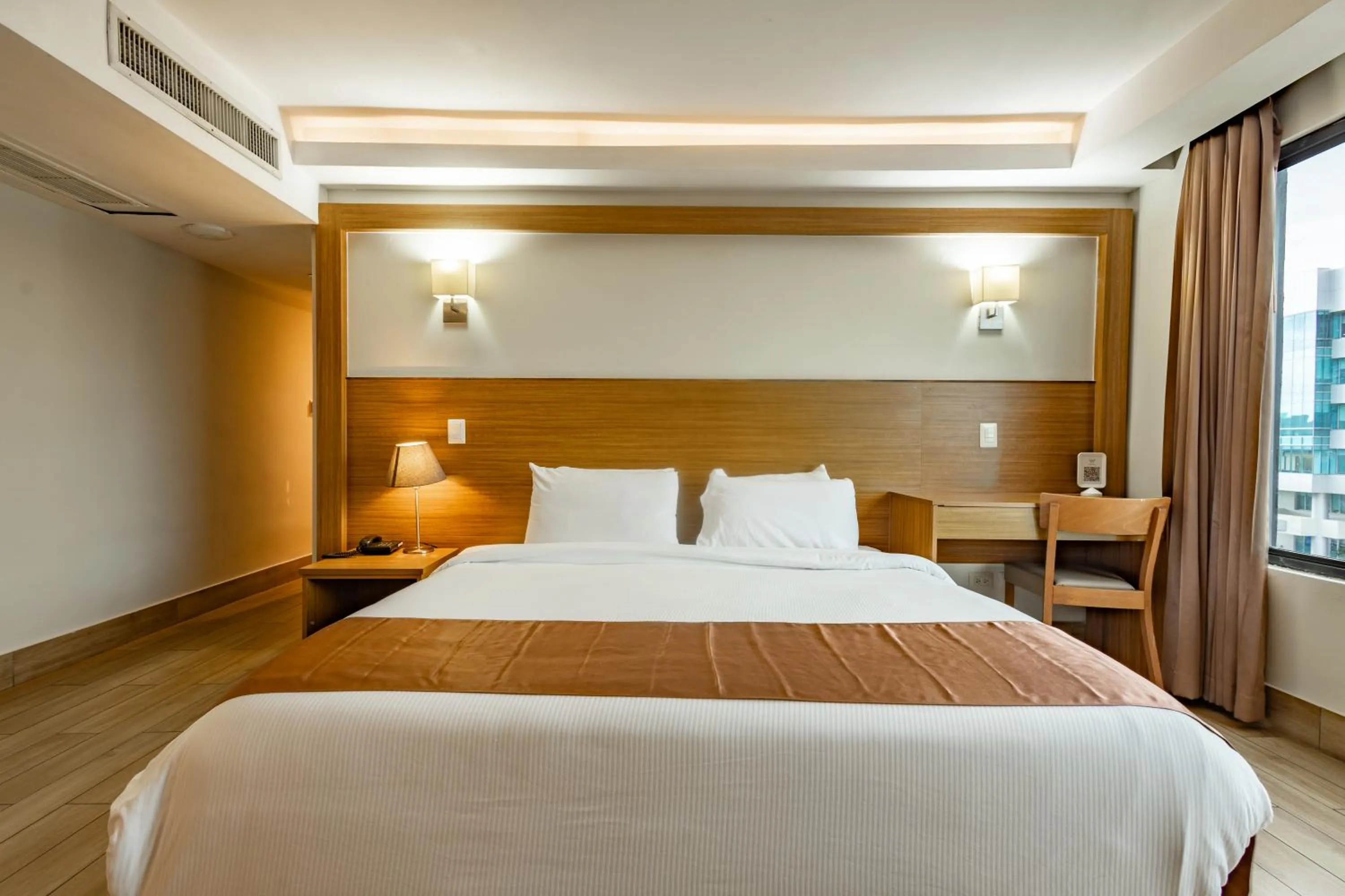 Bed in Weston Suites Hotel