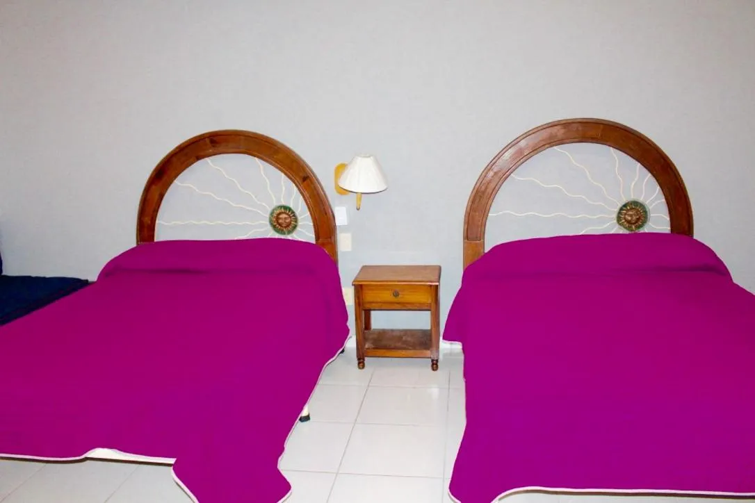 Bed in Hotel y Suites Corita
