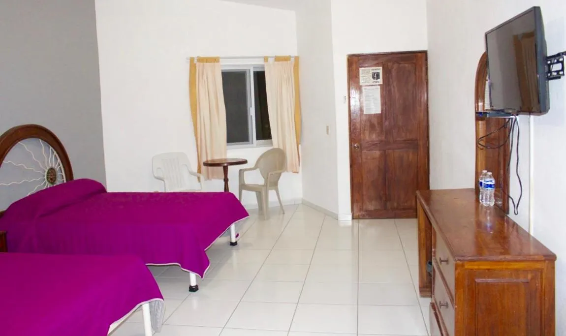 Bed in Hotel y Suites Corita