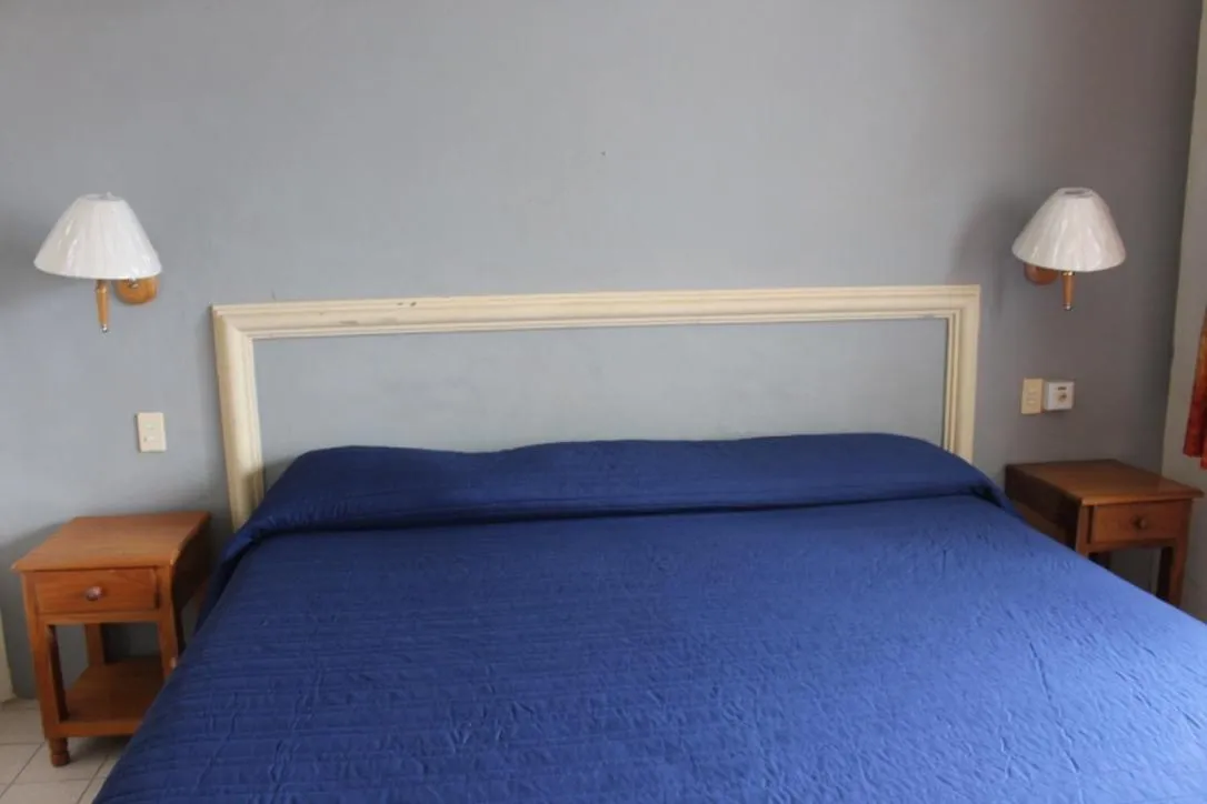 Bed in Hotel y Suites Corita