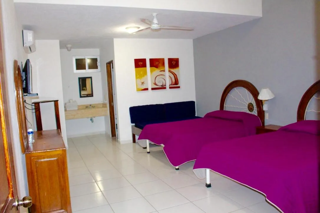 Bed in Hotel y Suites Corita