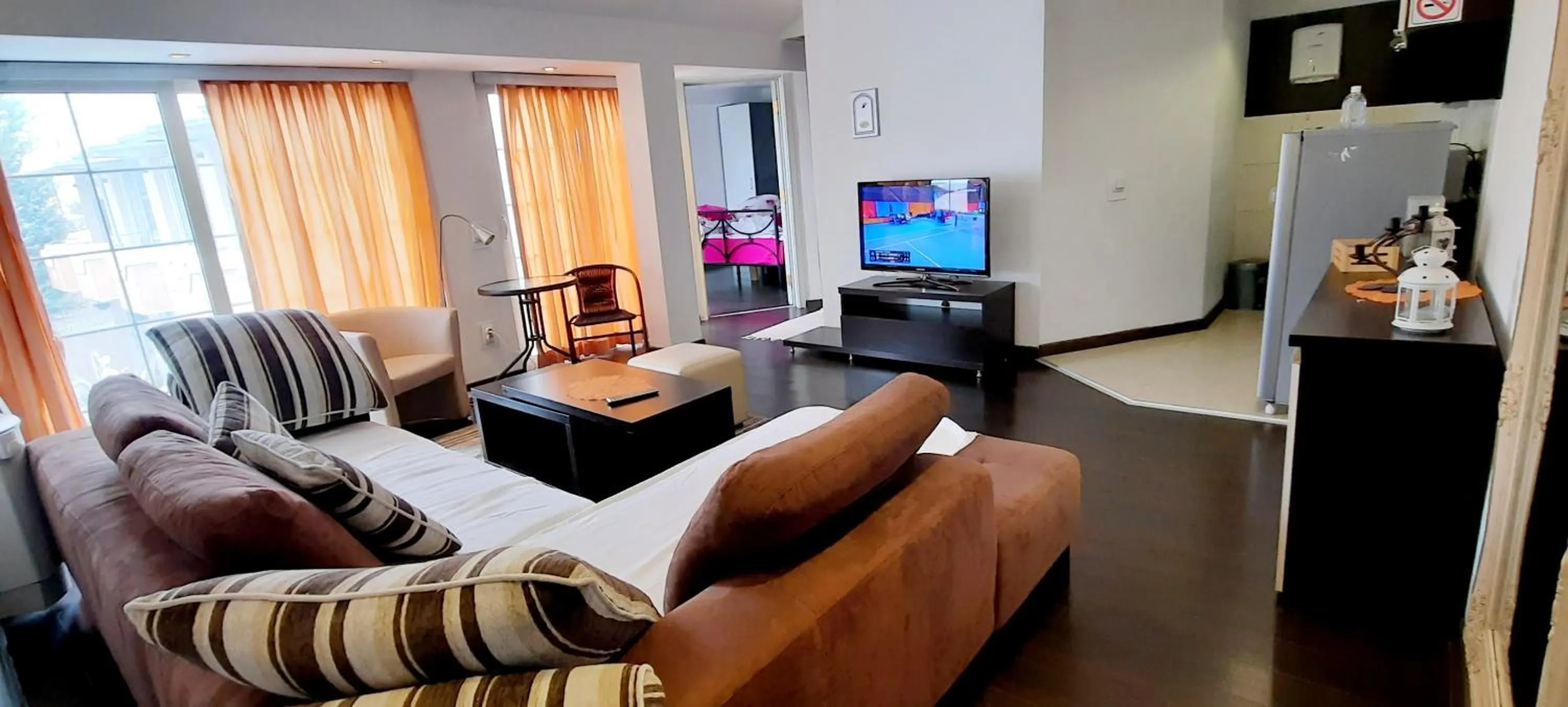 Living room in Aloha Apartments with pool