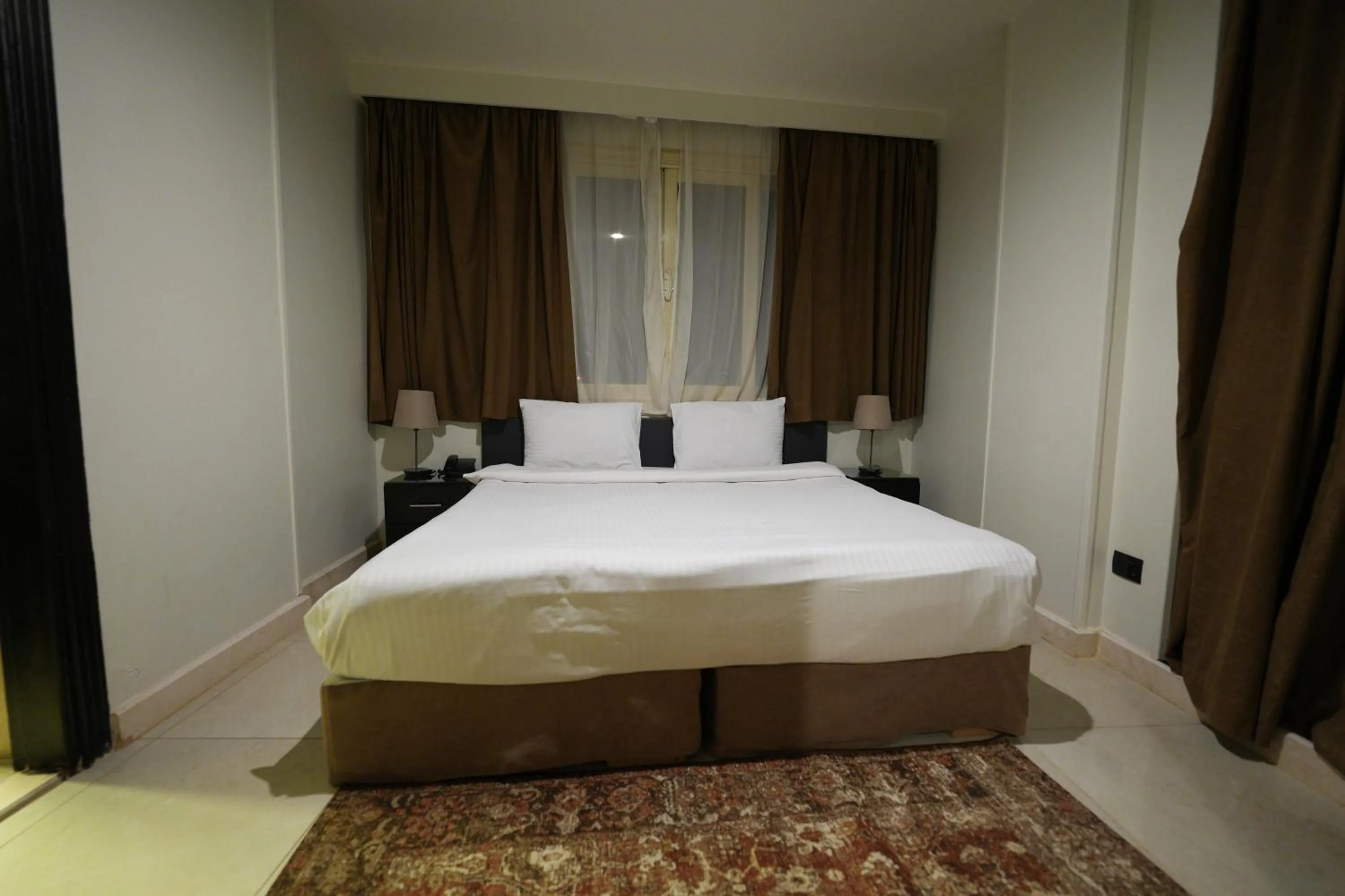 Bed in NewCity Hotel & Suites