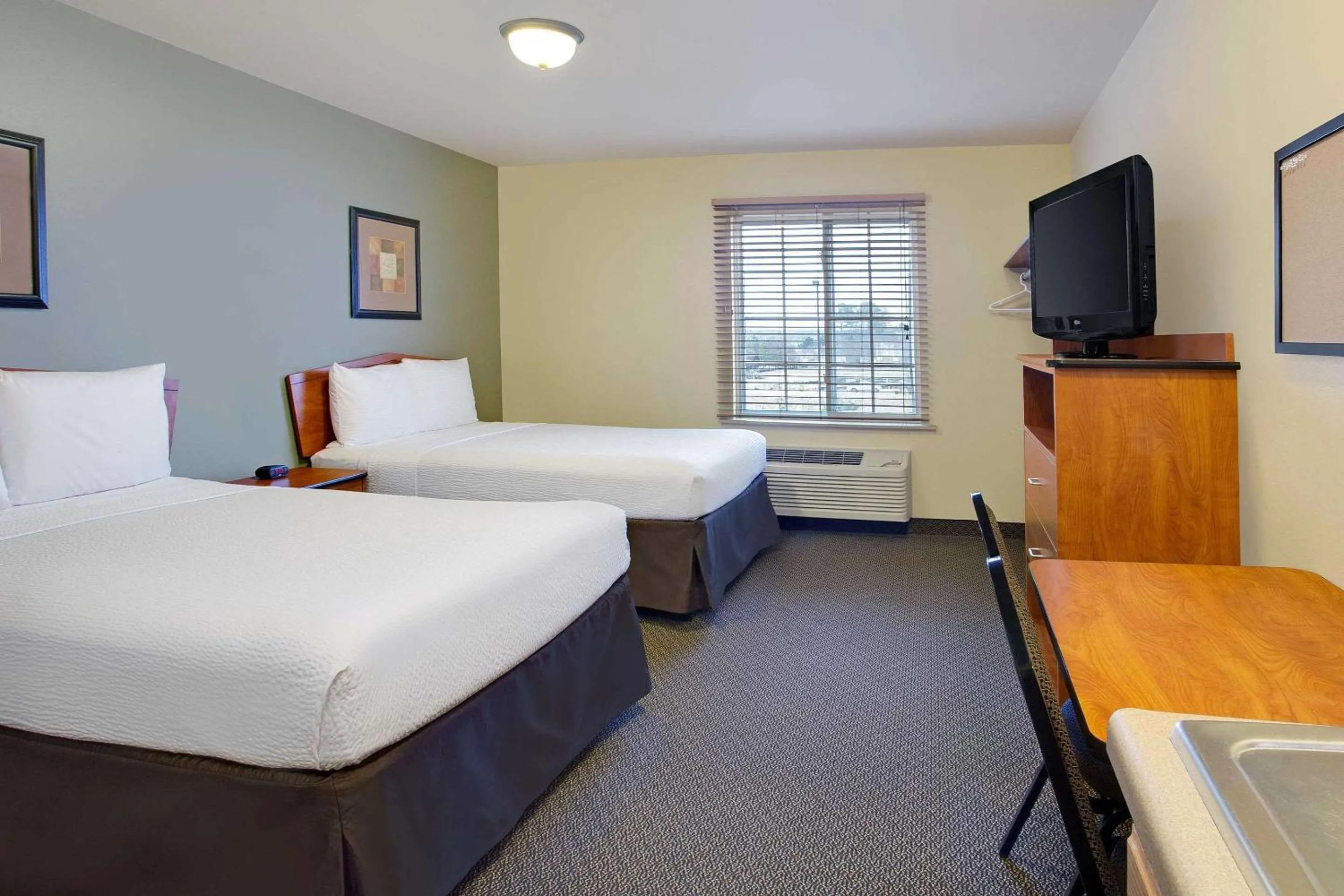 Photo of the whole room, Bed in WoodSpring Suites Raleigh Northeast Wake Forest