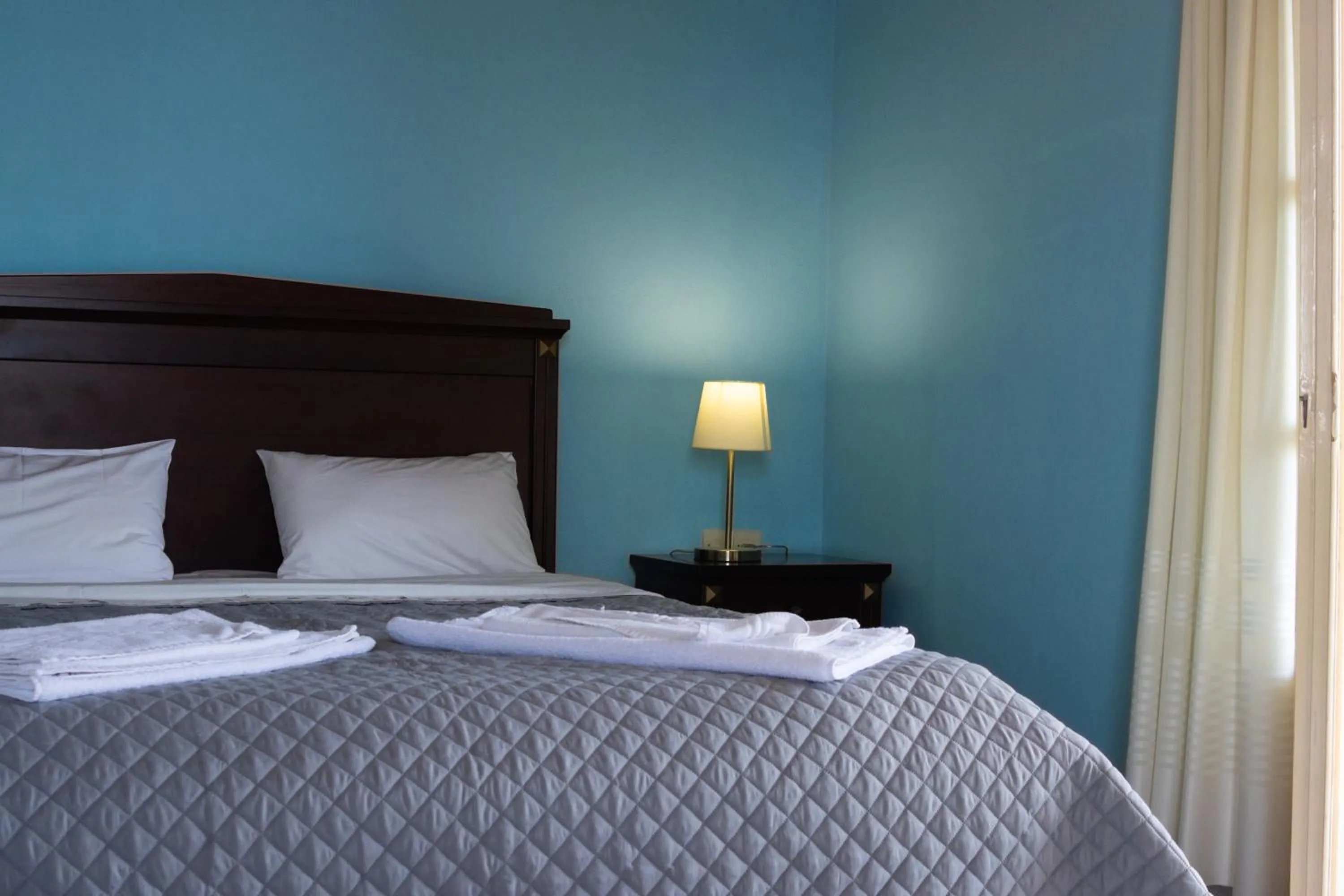 Bed in APRAOS BAY HOTEL