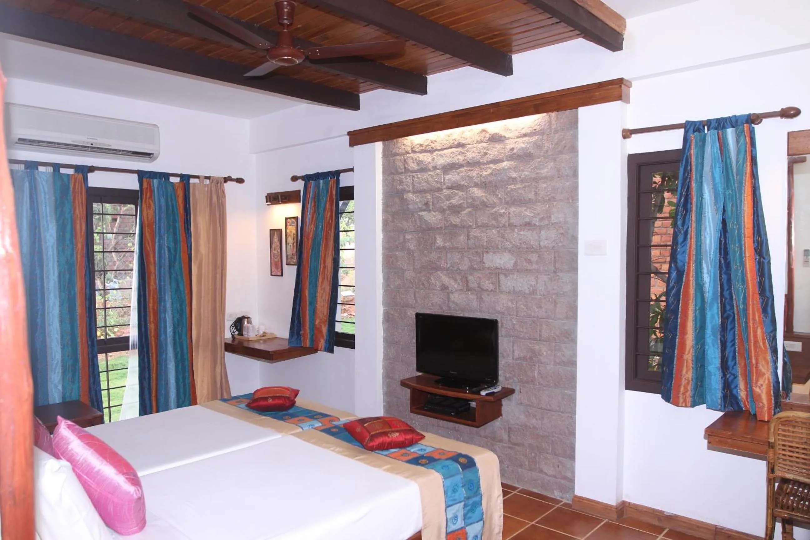 Bed in Kadambavanam Ethnic Village Resort