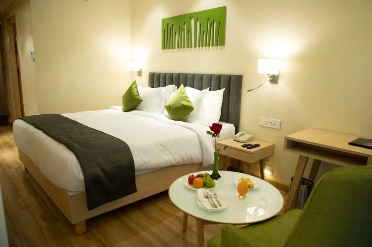 Photo of the whole room, Bed in Regenta Central Harsha Vapi