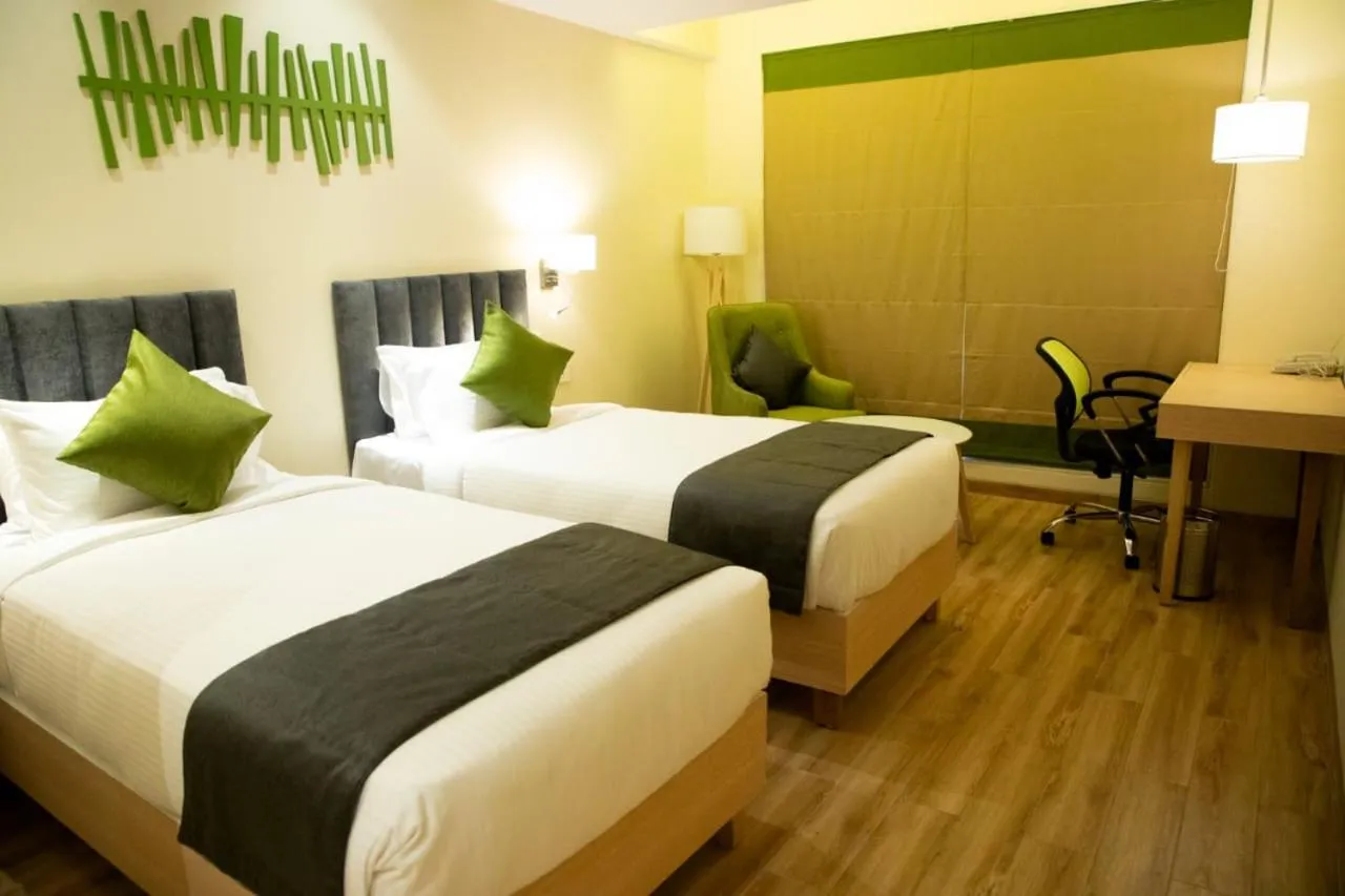 Photo of the whole room, Bed in Regenta Central Harsha Vapi