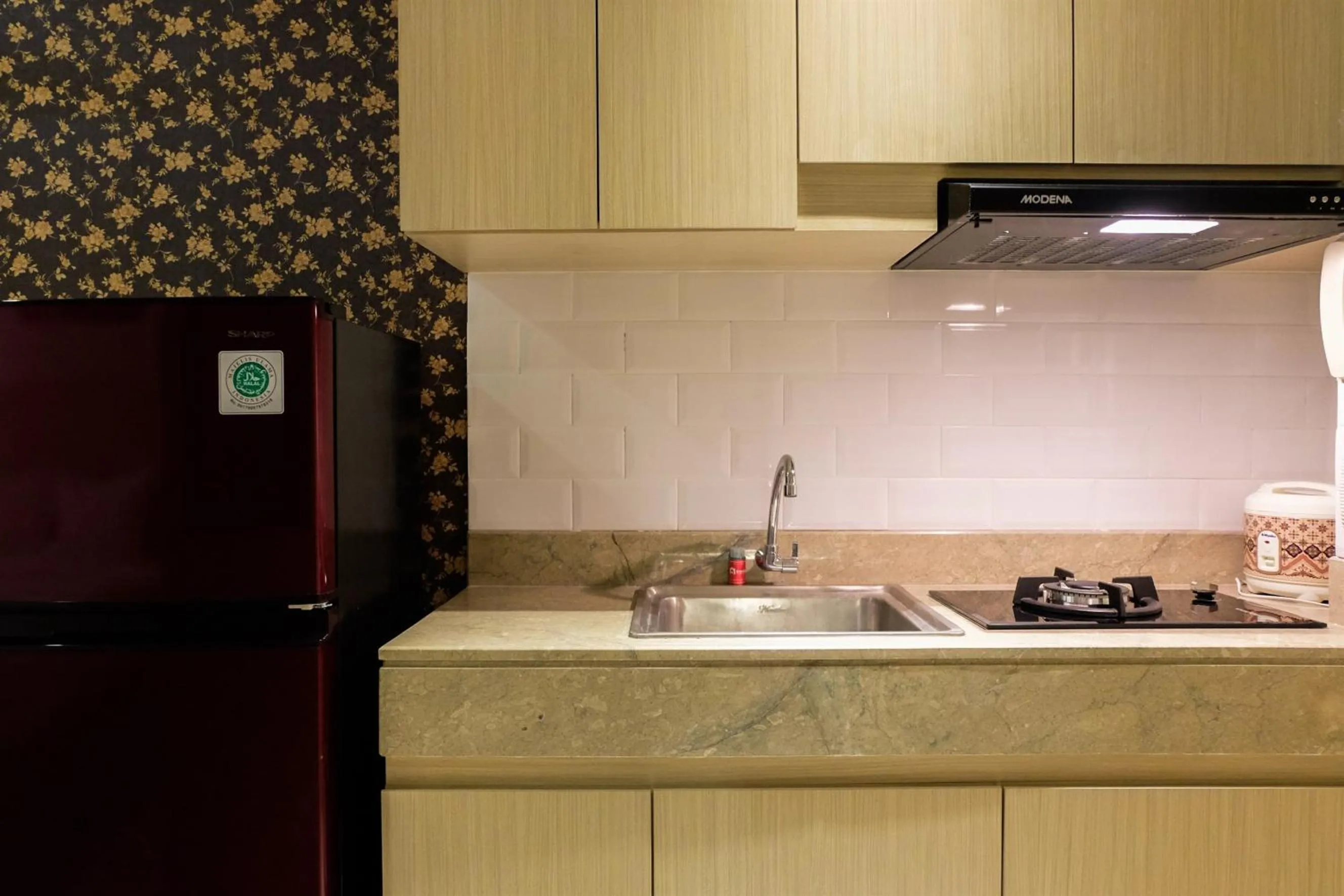 Kitchen or kitchenette in Prime Location Studio Apartment at Elpis Residence near Ancol By Travelio