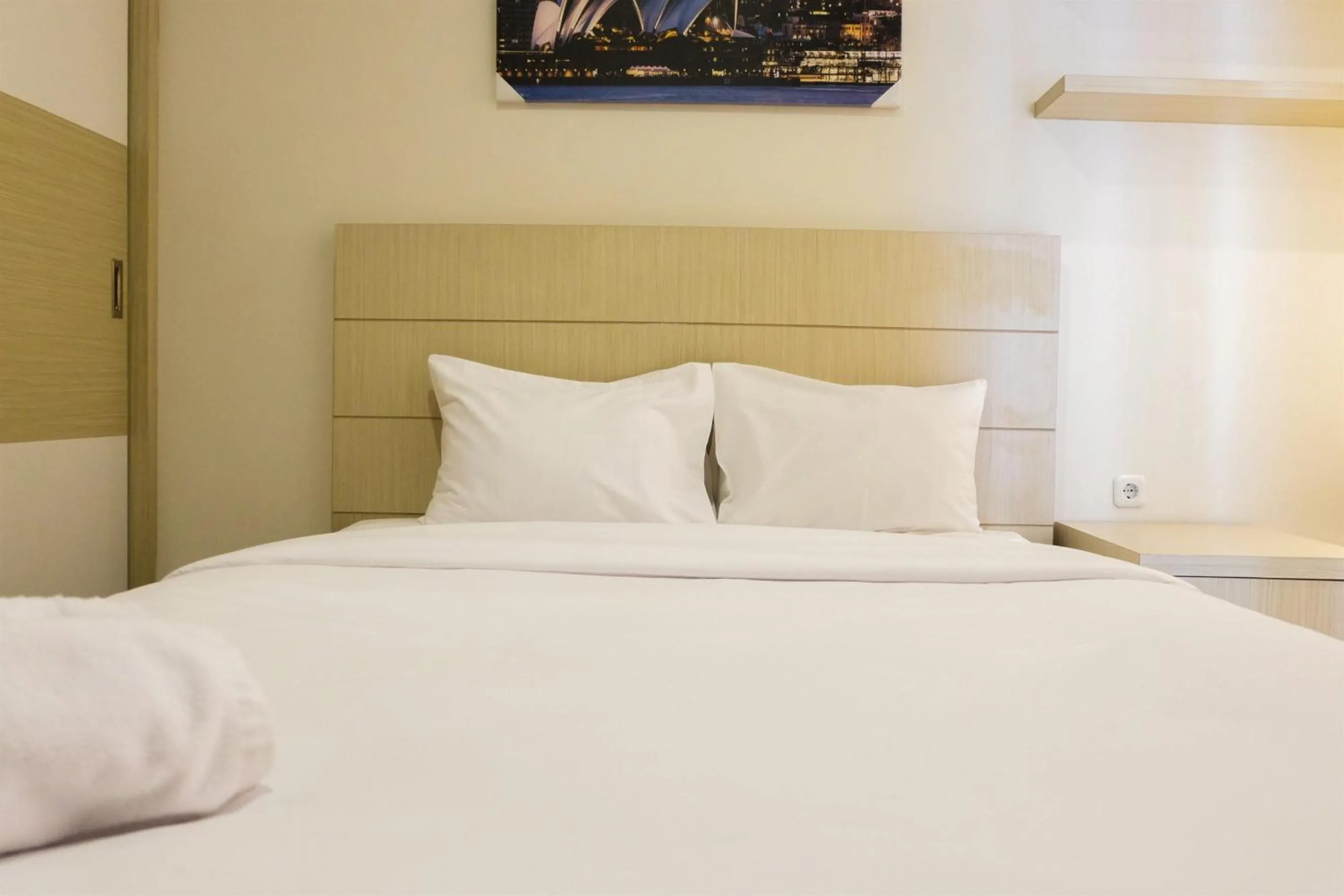 Bed in Prime Location Studio Apartment at Elpis Residence near Ancol By Travelio