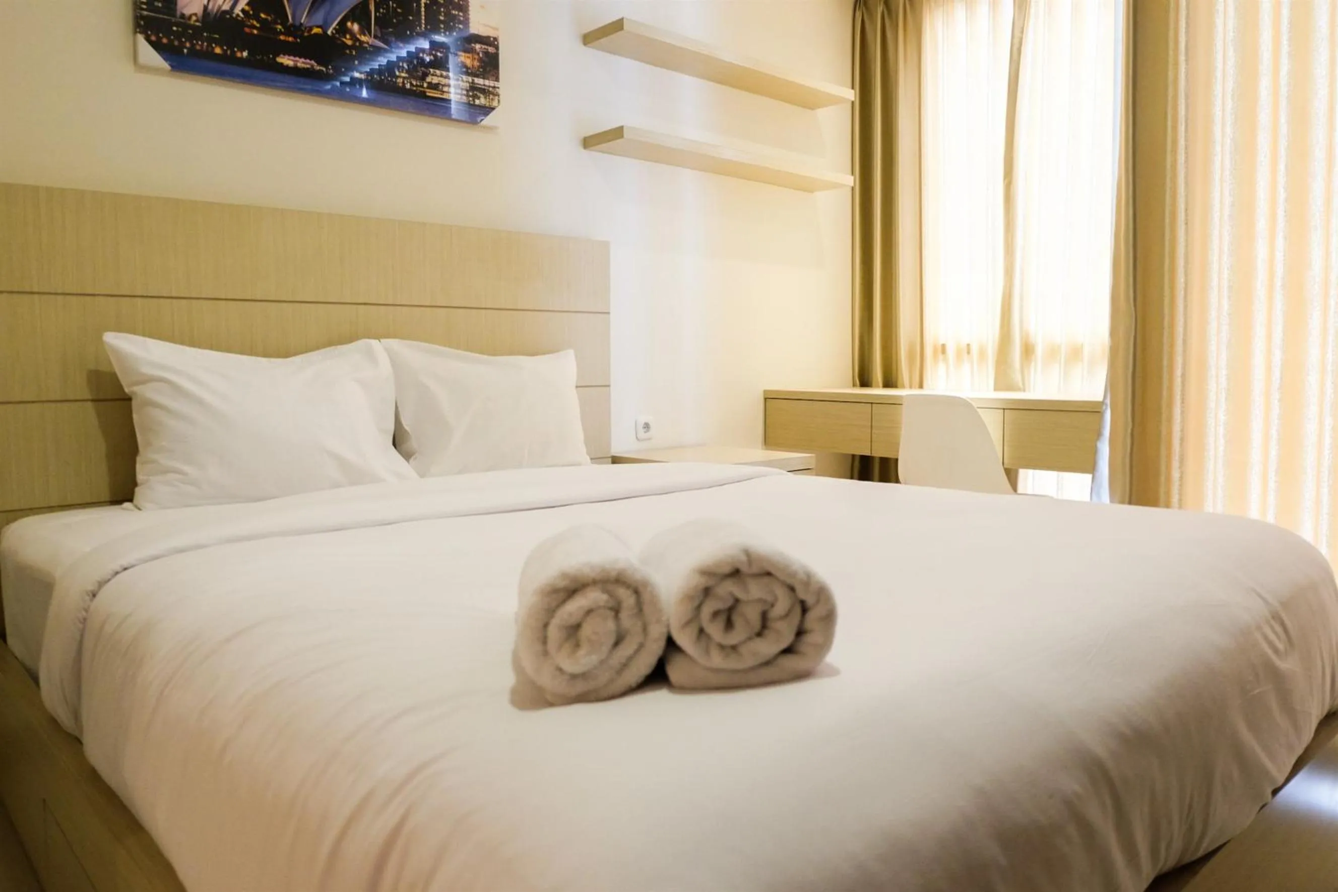 Bed in Prime Location Studio Apartment at Elpis Residence near Ancol By Travelio