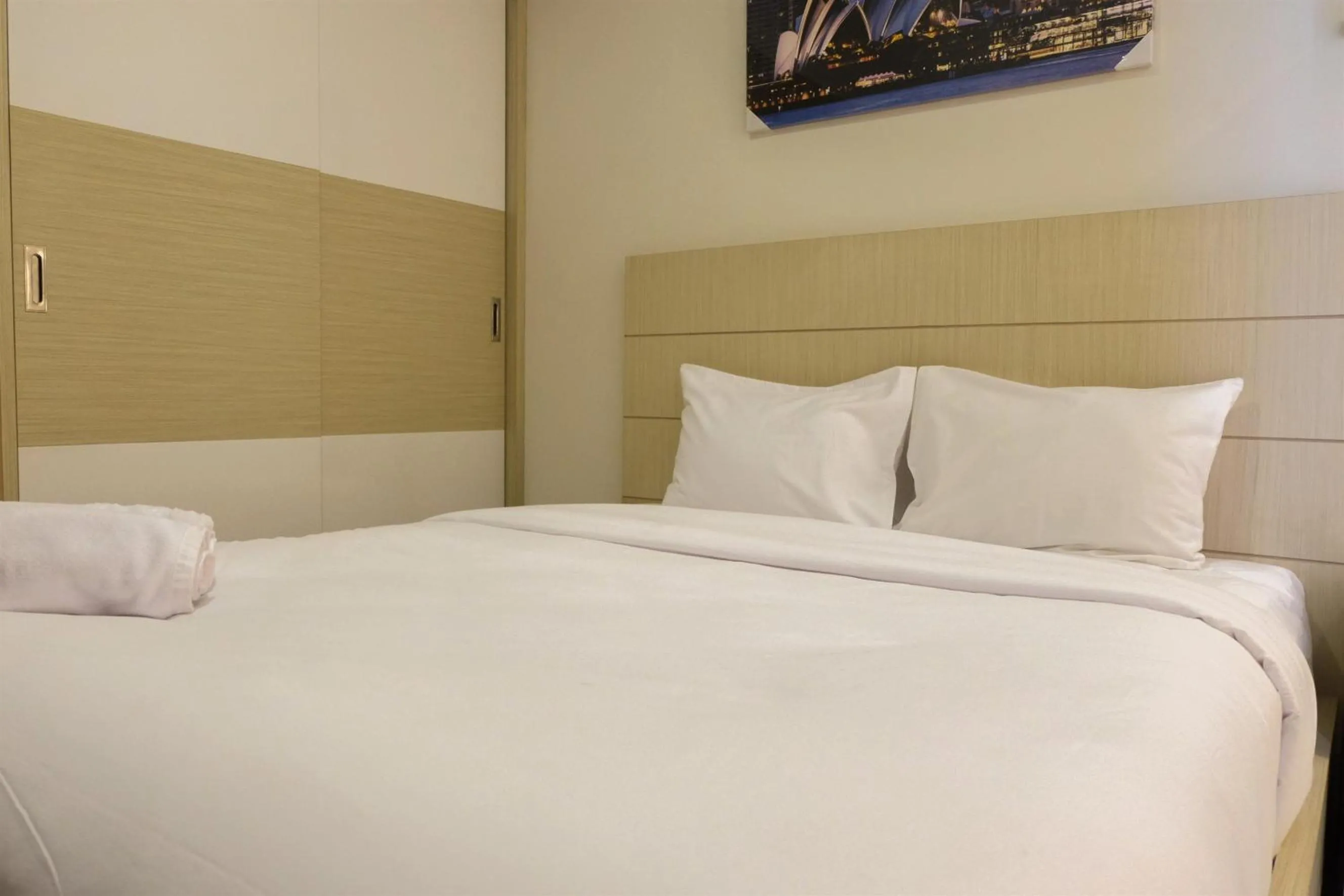 Bed in Prime Location Studio Apartment at Elpis Residence near Ancol By Travelio