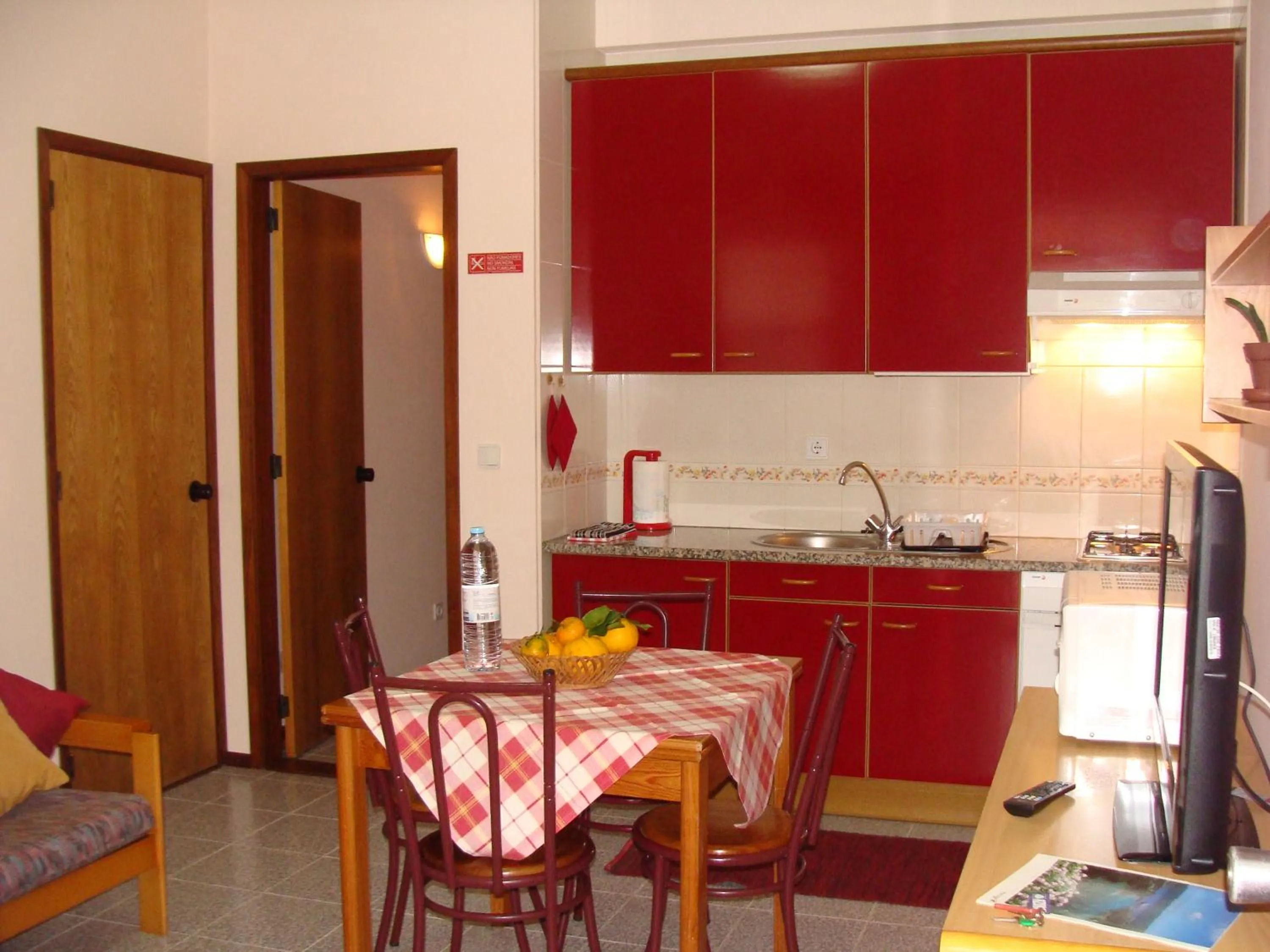 Kitchen or kitchenette in Apartamentos São João