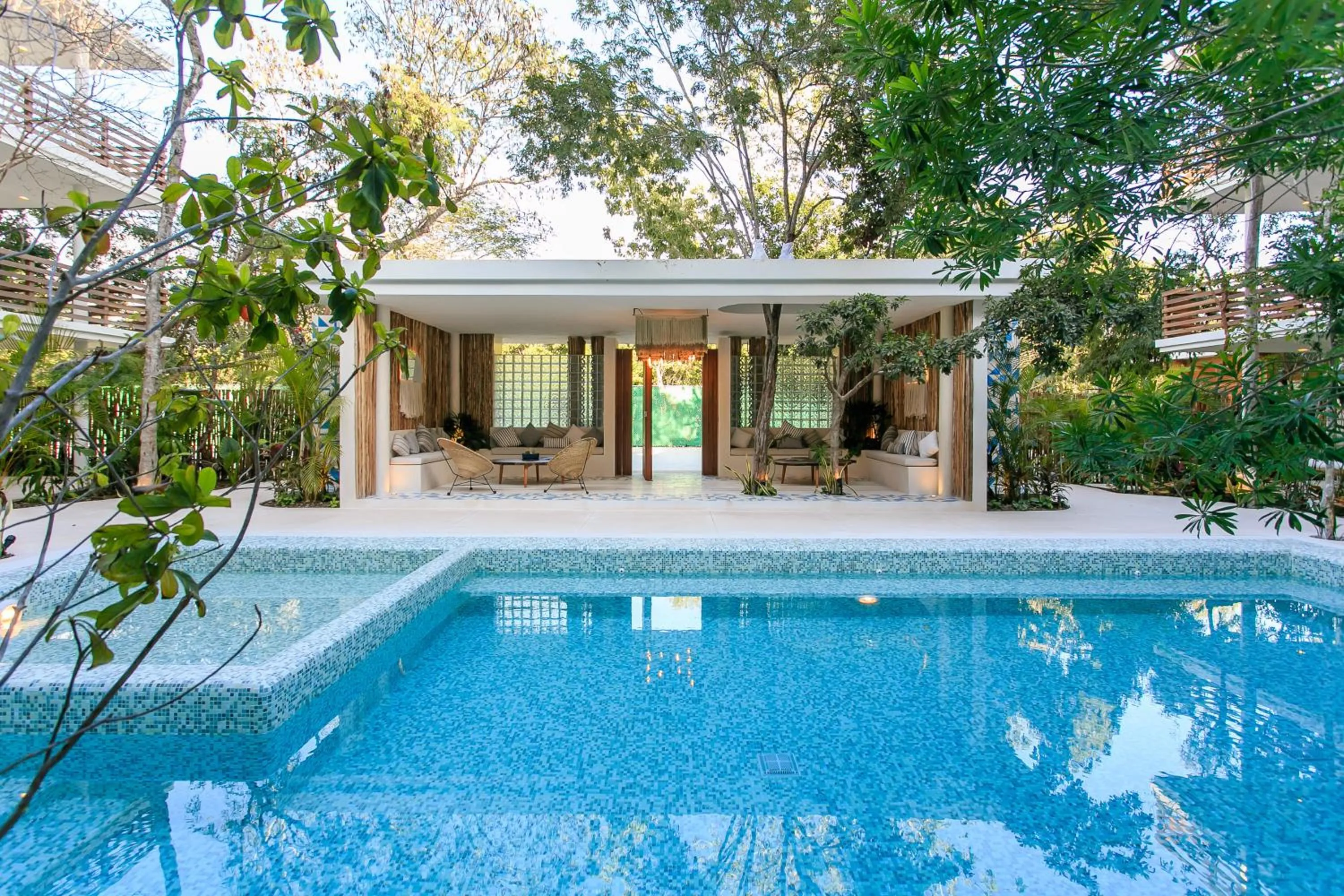 Swimming pool in Charming Nature-Inspired Condos with Sultry Surroundings by Stella Rentals